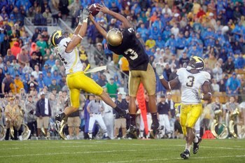 SOUTH BEND,IN - SEPTEMBER 13:  Morgan Trent #14 of the Michigan Wolverines reaches for the ball against Michael Floyd #3 of the Notre Dame Fighting Irish on September 13, 2008 at Notre Dame Stadium in South Bend, Indiana. (Photo by: Gregory Shamus/Getty I