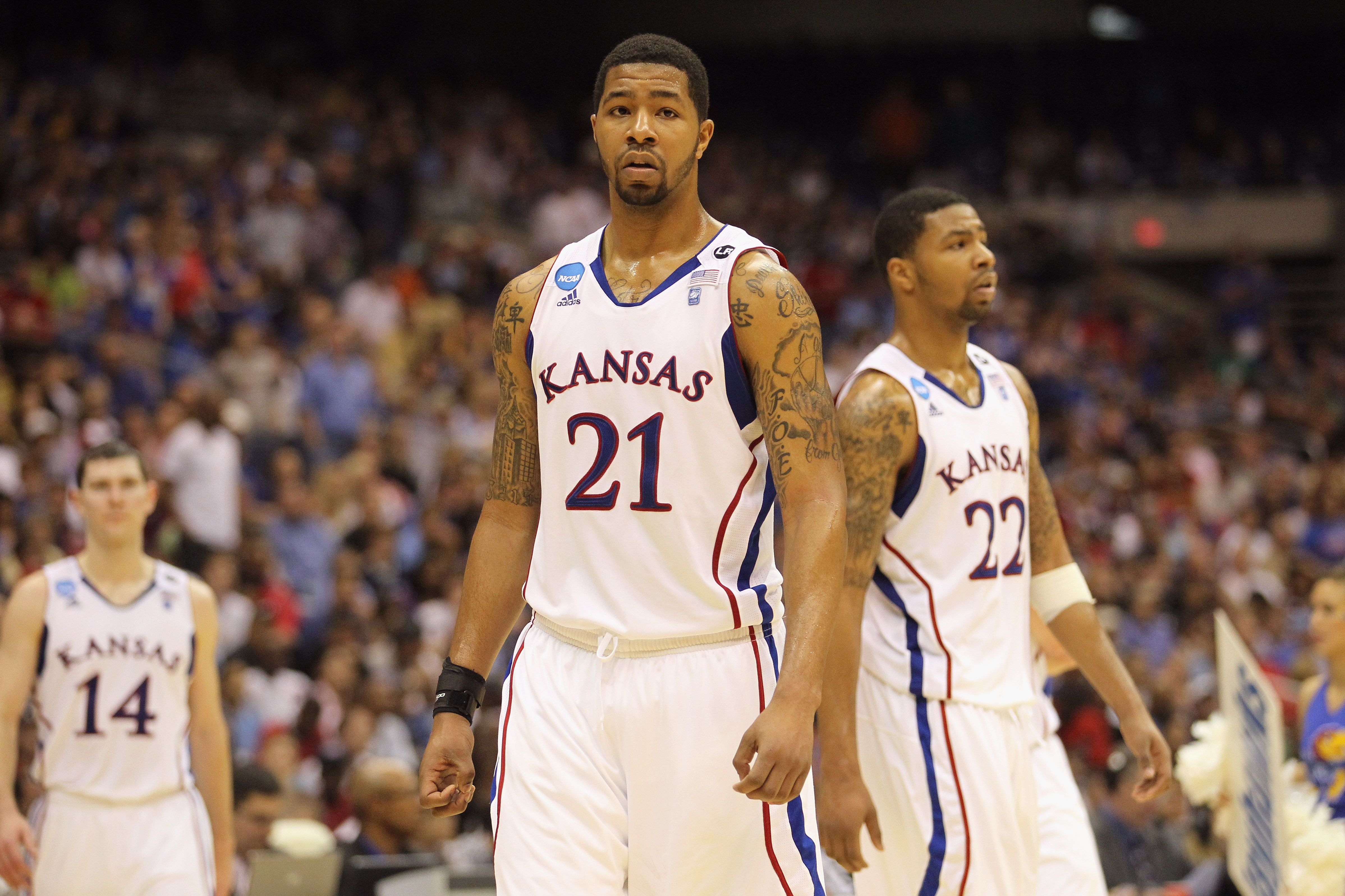 SAN ANTONIO, TX - MARCH 27:  Markieff Morris #21 and Marcus Morris #22 of the Kansas Jayhawks react during the southwest regional final of the 2011 NCAA men's basketball tournament against the Virginia Commonwealth Rams at the Alamodome on March 27, 2011