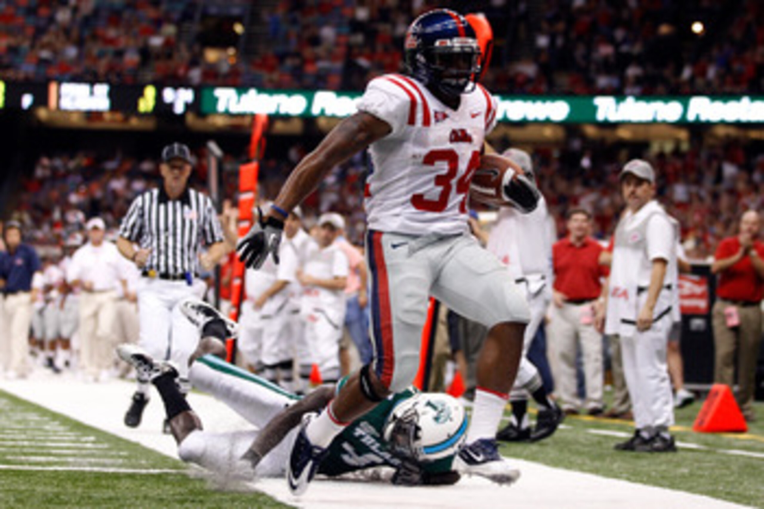 NEW ORLEANS - SEPTEMBER 11:  Brandon Bolden #34 of the Ole Miss Rebels scores a touchdown over Shakiel Smith #4 of the Tulane Green Wave at the Louisiana Superdome on September 11, 2010 in New Orleans, Louisiana.  (Photo by Chris Graythen/Getty Images)