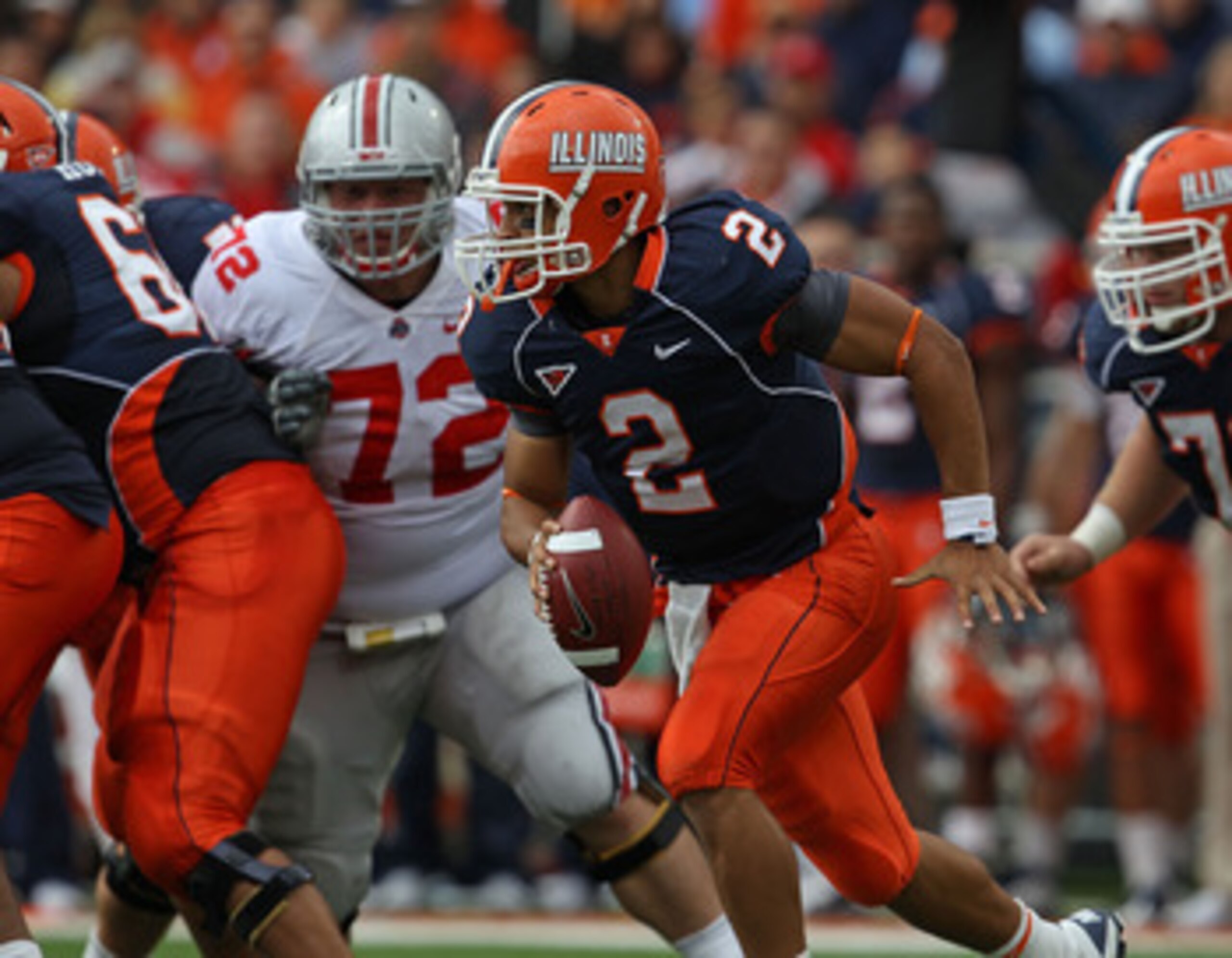 CHAMPAIGN, IL - OCTOBER 02: Nathan Scheelhaase #2 of the Illinois Fighting Illini runs against the Ohio State Buckeyes as Dexter Larimore #72 pursues at Memorial Stadium on October 2, 2010 in Champaign, Illinois. Ohio State defeated Illinois 24-13. (Photo