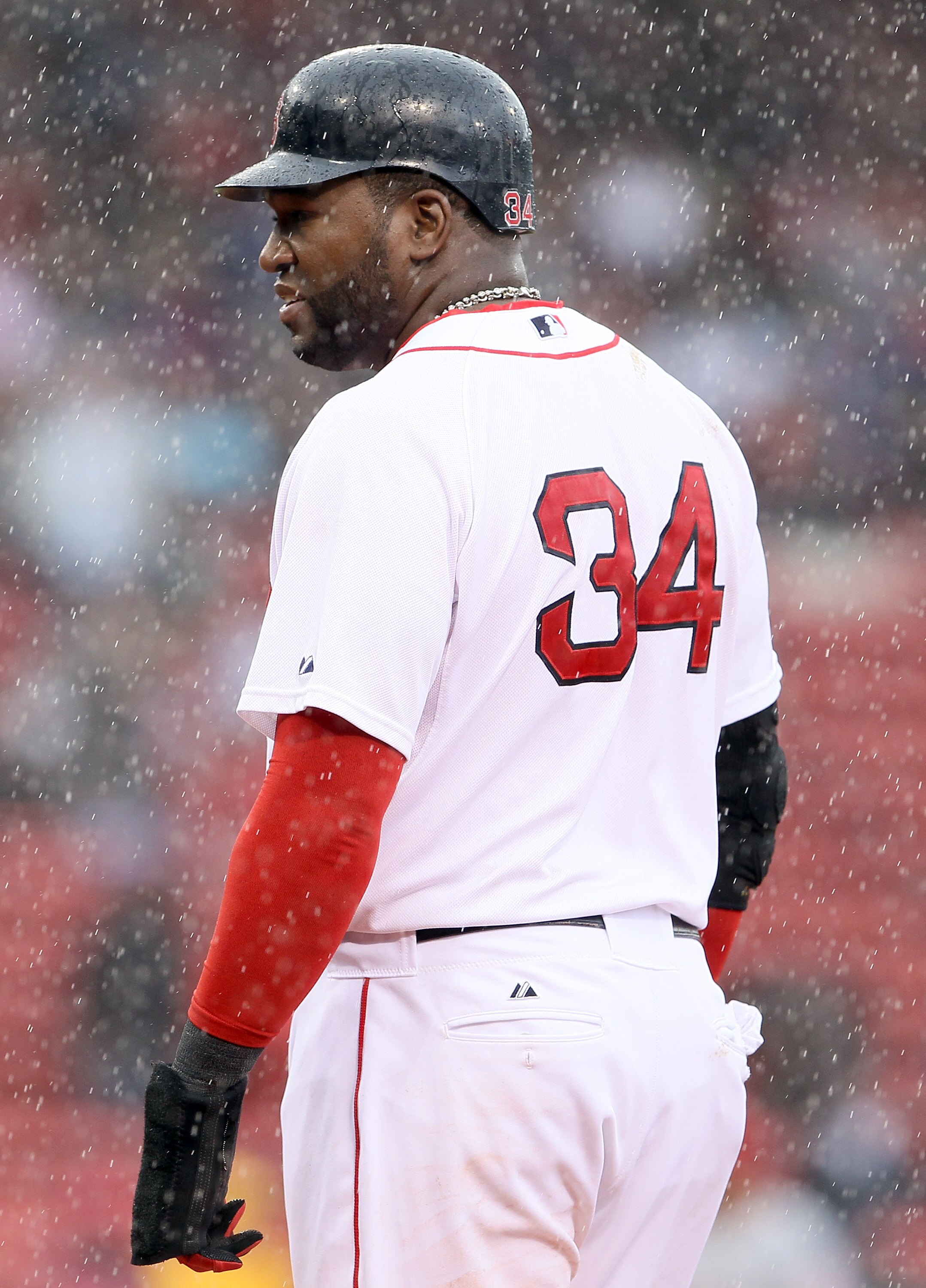 BOSTON, MA - MAY 05:  David Ortiz #34 of the Boston Red Sox stands on first base as it rains against the Los Angeles Angels on May 5, 2011 at Fenway Park in Boston, Massachusetts. The Los Angeles Angels defeated the Boston Red Sox 11-0.  (Photo by Elsa/Ge