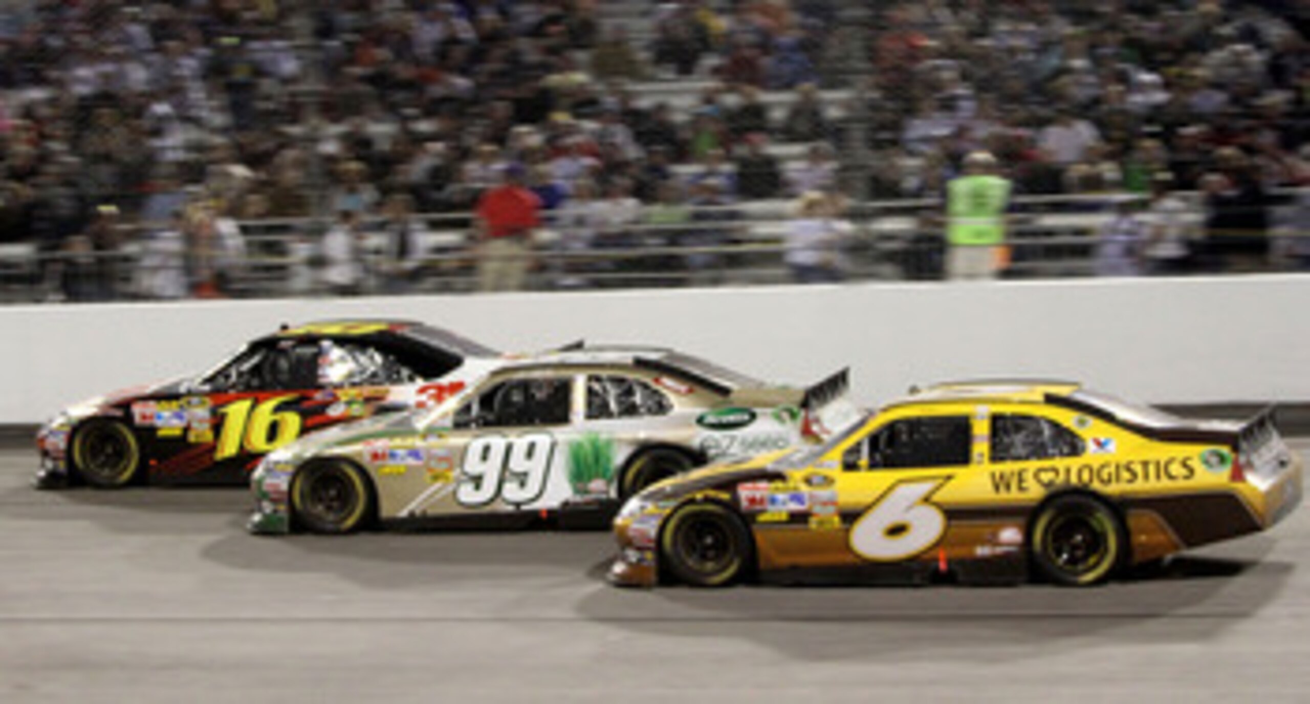 RICHMOND, VA - APRIL 30: David Ragan, driver of the #6 UPS Ford races with Carl Edwards, driver of the #99 Scotts eZ Seed Ford and Greg Biffle, driver of the #16 3M Ford during the NASCAR Sprint Cup Series Crown Royal Presents The Matthew & Daniel Hansen