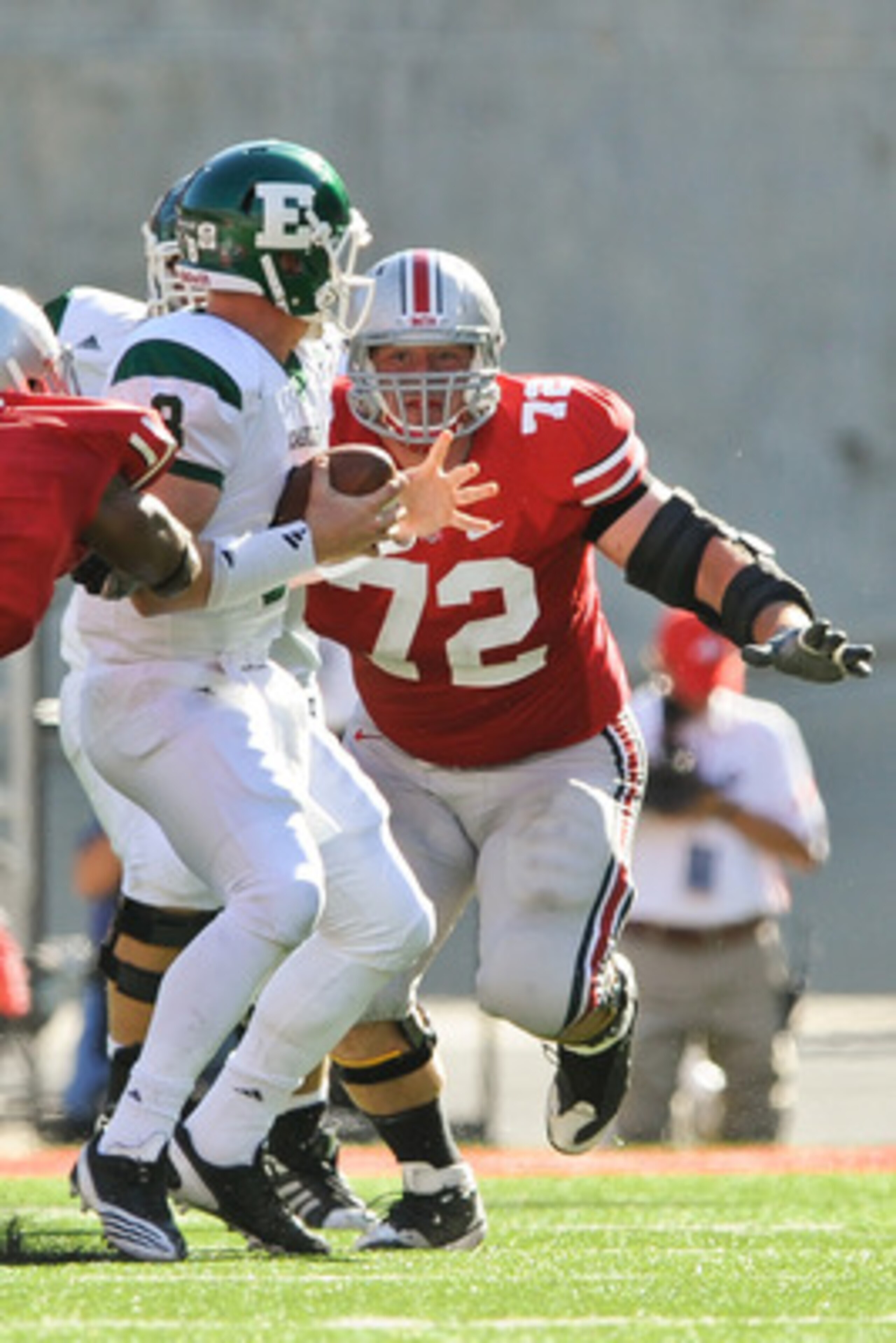 COLUMBUS, OH - SEPTEMBER 25:  Dexter Larimore #72 of the Ohio State Buckeyes chases down quarterback Alex Gillett  #8 of the Eastern Michigan Eagles at Ohio Stadium on September 25, 2010 in Columbus, Ohio.  Ohio State won 73-20. (Photo by Jamie Sabau/Gett