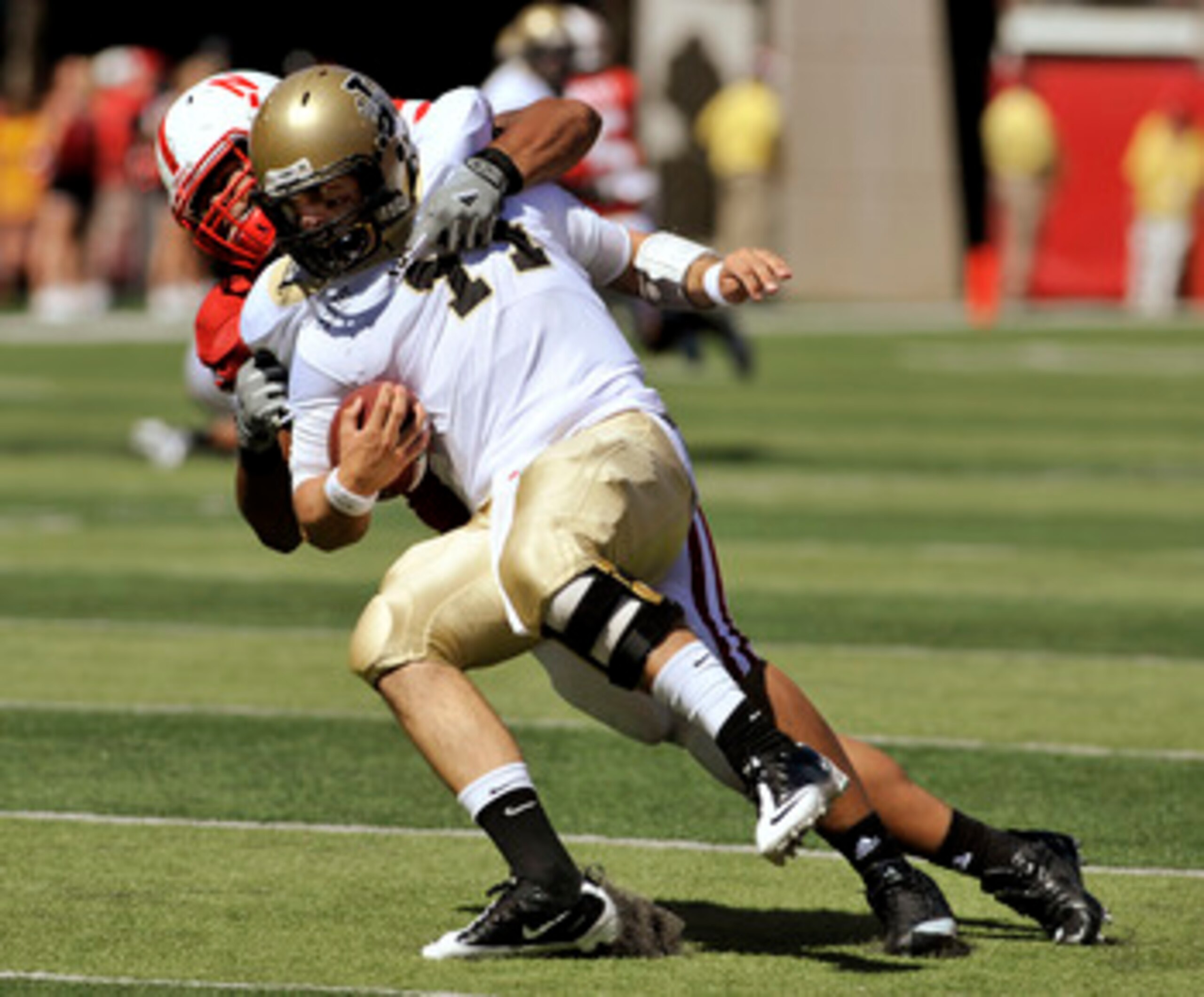 LINCOLN, NEBRASKA - SEPTEMBER 11: Nebraska Cornhuskers defensive tackle Terrence Moore #90 takes down Idaho Vandals quarterback Brian Reader #14 during second half action of their game at Memorial Stadium on September 4, 2010 in Lincoln, Nebraska. Nebrask