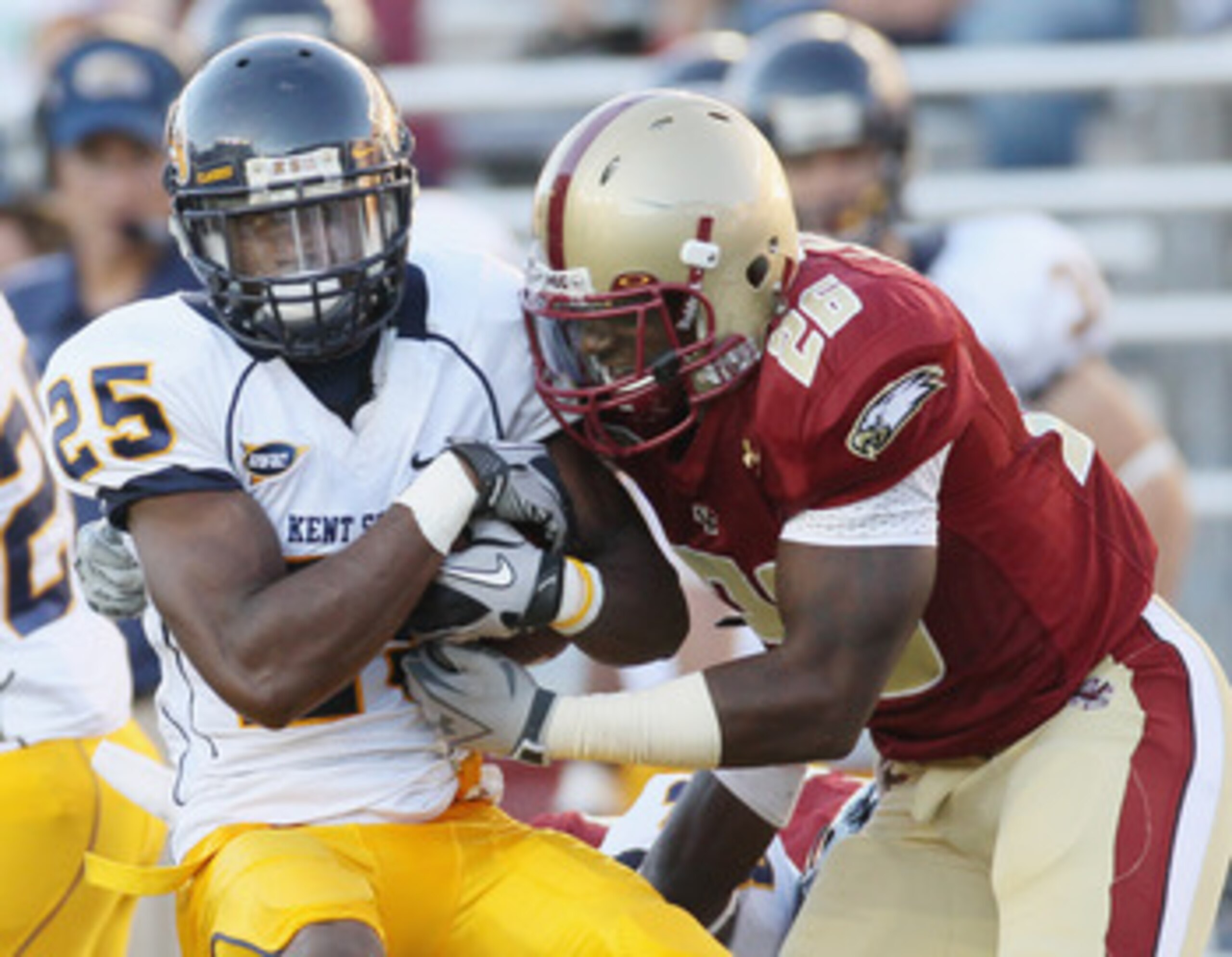 CHESTNUT HILL, MA - SEPTEMBER 11:  Anthony Bowman Jr. #26 of the Kent State Golden Flashes is tackled by Dominick LeGrande #26 of the Boston College Eagles on September 11, 2010 at Alumni Stadium in Chestnut Hill, Massachusetts. Boston College defeated Ke