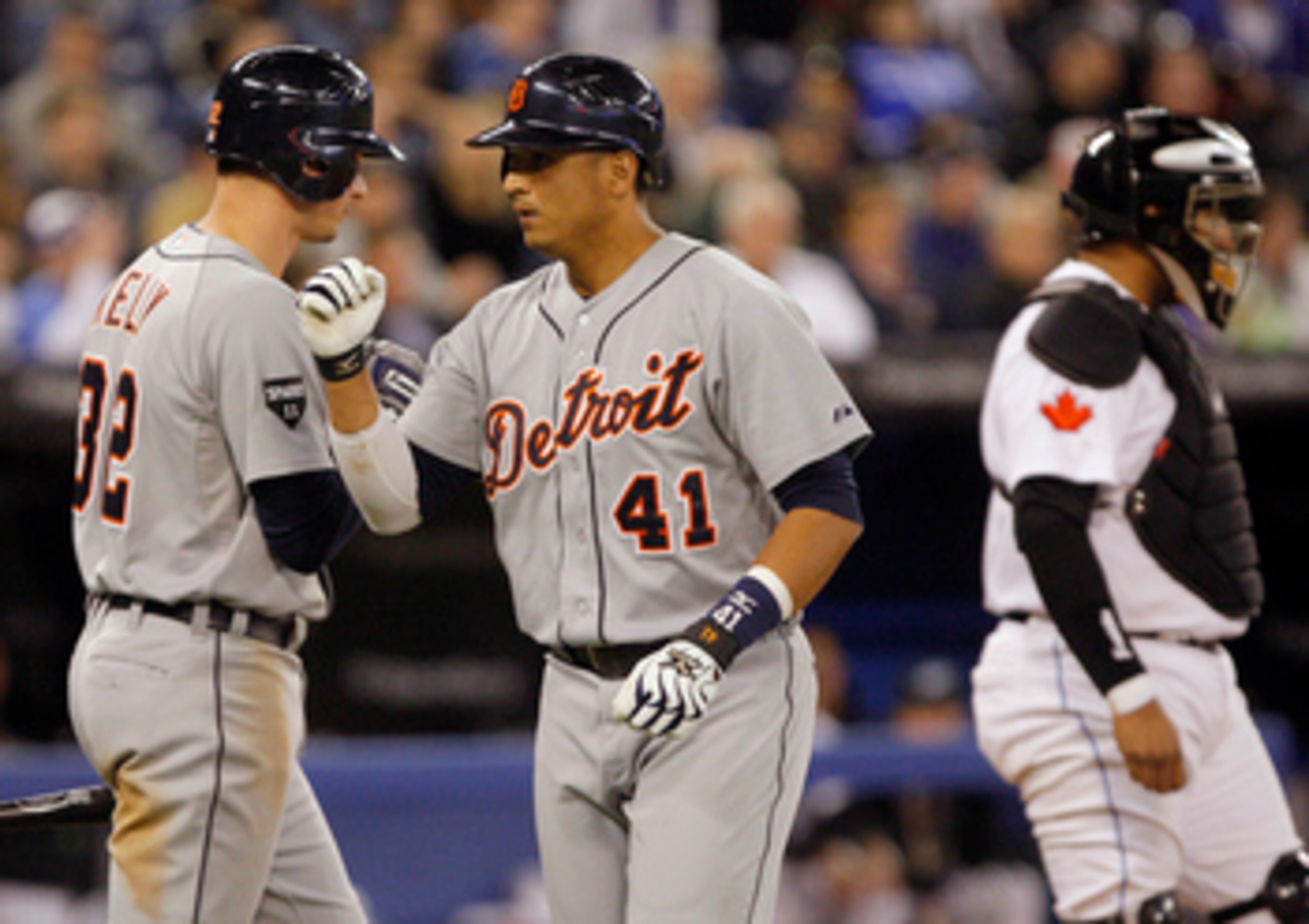 TORONTO, CANADA - MAY 9: Victor Martinez #41 and Don Kelly #32 of the Detroit Tigers celebrate a home run in front of Jose Molina #8 of the Toronto Blue Jays during MLB action at the Rogers Centre May 9, 2011 in Toronto, Ontario, Canada. (Photo by Abelima
