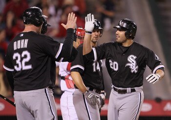 ANAHEIM, CA - MAY 09:  Carlos Quentin #20 and Adam Dunn #32 of the Chicago White Sox celebrate Quentin's three-run home run against the Los Angeles Angels of Anaheim in the seventh inning at Angel Stadium of Anaheim on May 9, 2011 in Anaheim, California. 