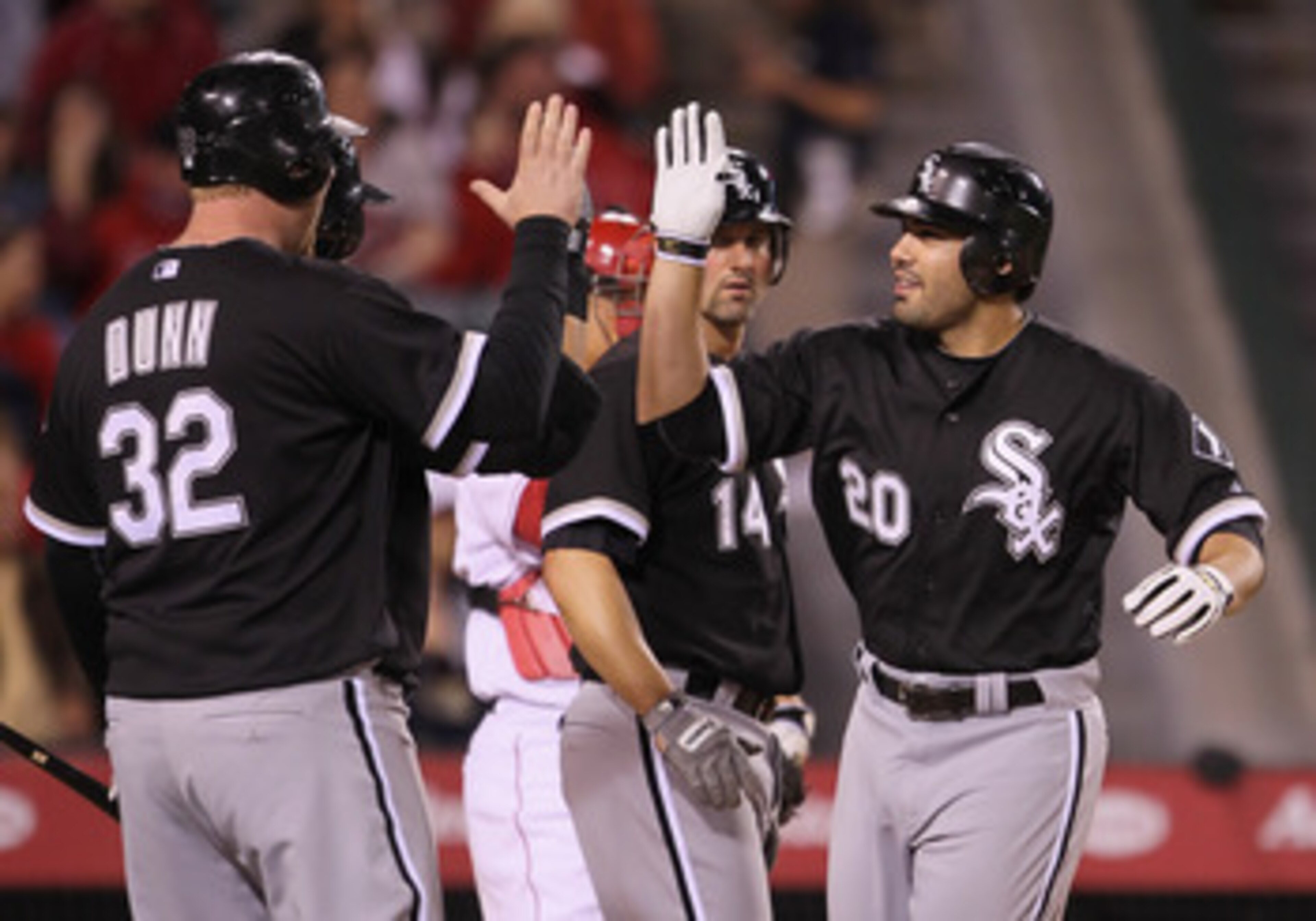 ANAHEIM, CA - MAY 09:  Carlos Quentin #20 and Adam Dunn #32 of the Chicago White Sox celebrate Quentin's three-run home run against the Los Angeles Angels of Anaheim in the seventh inning at Angel Stadium of Anaheim on May 9, 2011 in Anaheim, California. 
