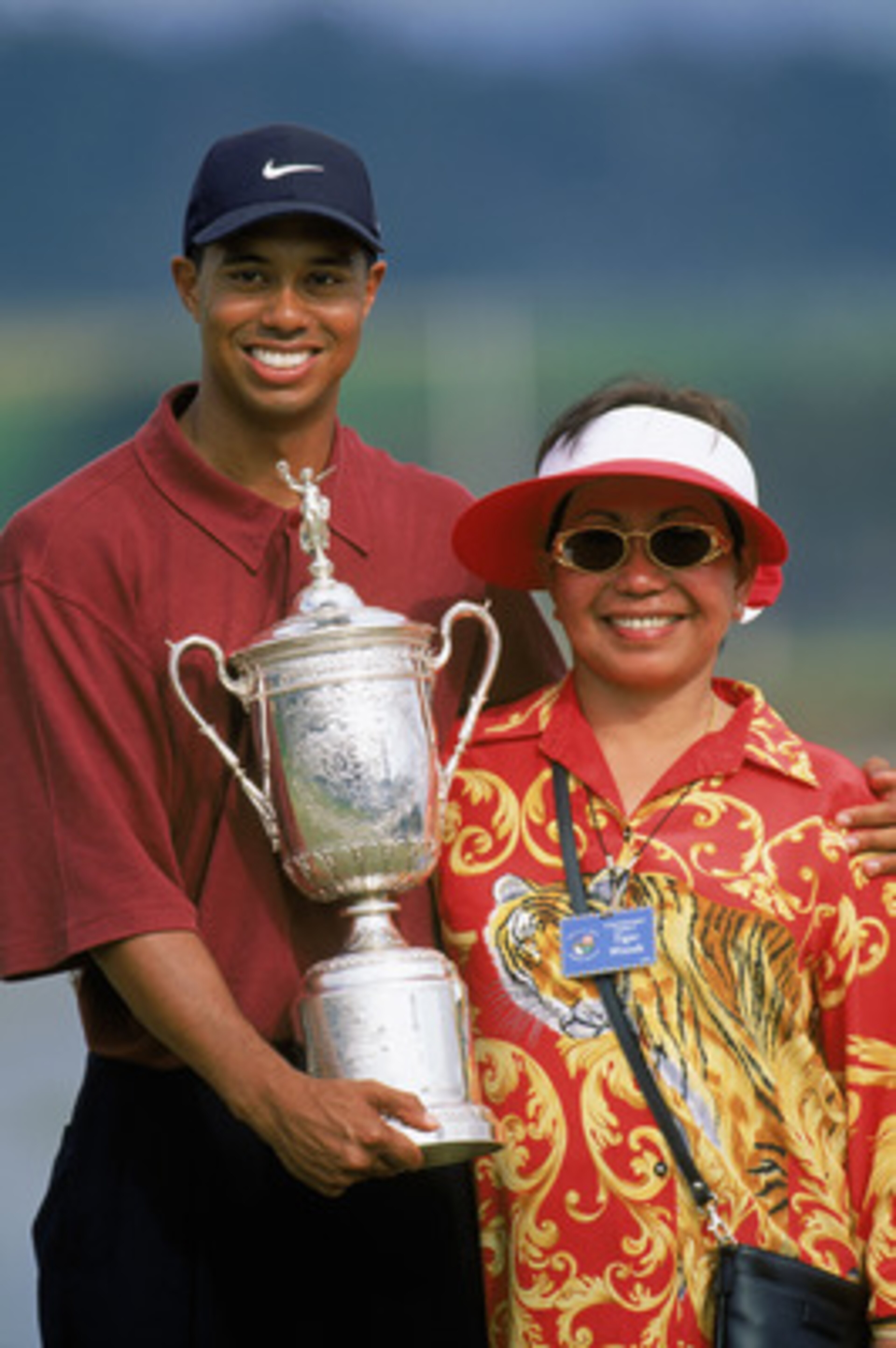PEBBLE BEACH, CA - JUNE 18:  Tiger Woods holds the trophy as he poses with his mother Kultida Woods after winning the 100th US Open at the Pebble Beach Golf Links on June 18, 2000 in Pebble Beach, California.  (Photo by Jamie Squire/Getty Images)