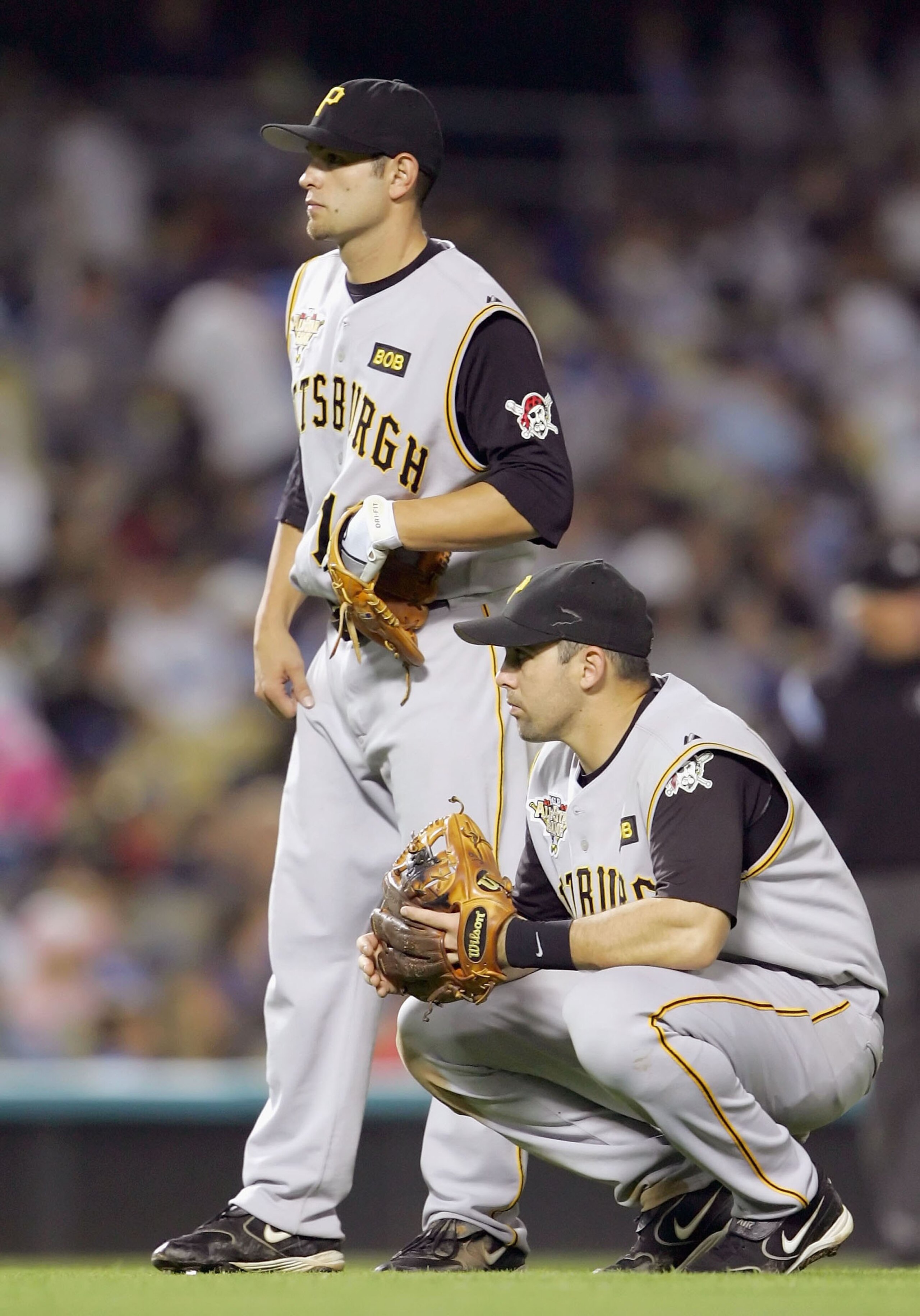 LOS ANGELES - SEPTEMBER 21:   (L-R) Freddy Sanchez #12 and Jack Wilson #2 of the Pittsburgh Pirates wait in the infield durng a pitching change against the Los Angeles Dodgers on September 21, 2006 at Dodger Stadium in Los Angeles, California.  (Photo by