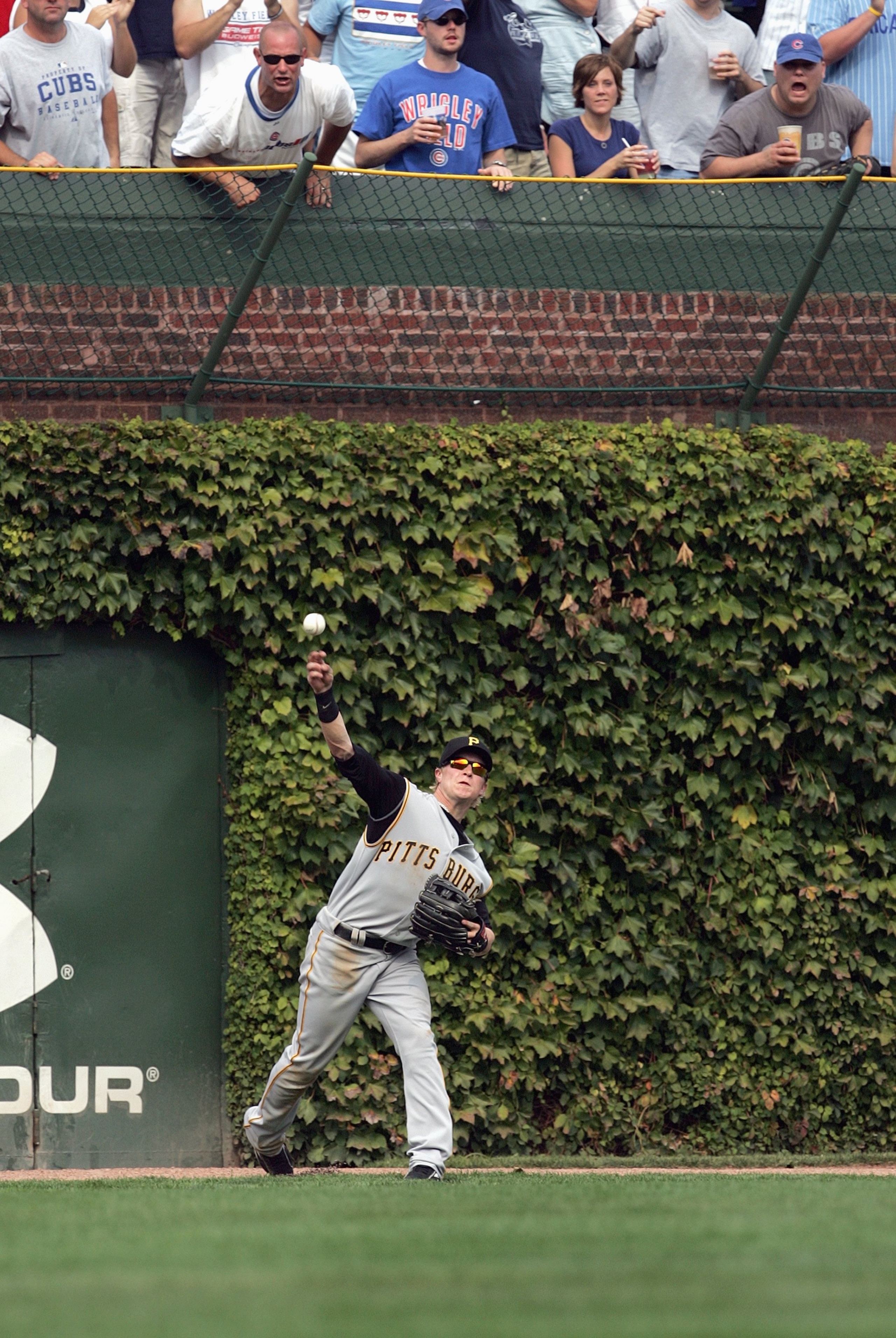 CHICAGO - SEPTEMBER 21: Nate McLouth #13 of the Pittsburgh Pirates throws the ball by Ryan Theriot #2 of the Chicago Cubs as fans jeer him at Wrigley Field September 21, 2007 in Chicago, Illinois. The Cubs defeated the Pirates 13-7. (Photo by Jonathan Dan