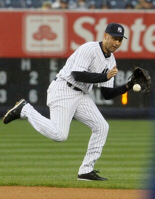 NEW YORK, NY - APRIL 16:  Derek Jeter #2 of the New York Yankees fields the ball against the Texas Rangers on April 16, 2011 at Yankee Stadium in the Bronx borough of New York City. The Yankees defeated the Rangers 5-2.  (Photo by Jim McIsaac/Getty Images