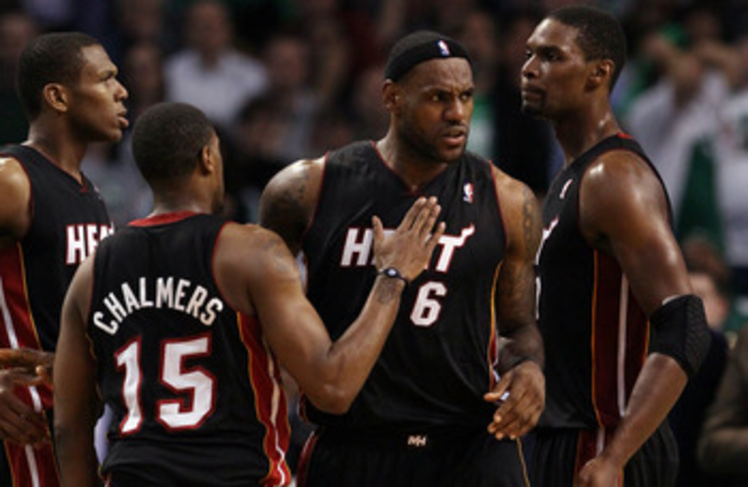 BOSTON, MA - MAY 09: LeBron James #6 of the Miami Heat is congratulated by teammates Chris Bosh  #1 and Mario Chalmers #15 after James drew the foul in the second half against the Boston Celtics in Game Four of the Eastern Conference Semifinals in the 201