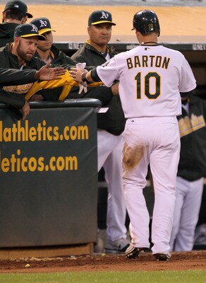OAKLAND, CA - MAY 03: Daric Barton #10 of the Oakland Athletics is congratulated by teammates after he scored on a ground out by Kurt Suzuki #8 of the Oakland Athletics in the fourth inning of their game against the Cleveland Indians at Oakland-Alameda C OAKLAND, CA - MAY 03: Daric Barton #10 of the Oakland Athletics is congratulated by teammates after he scored on a ground out by Kurt Suzuki #8 of the Oakland Athletics in the fourth inning of their game against the Cleveland Indians at Oakland-Alameda C