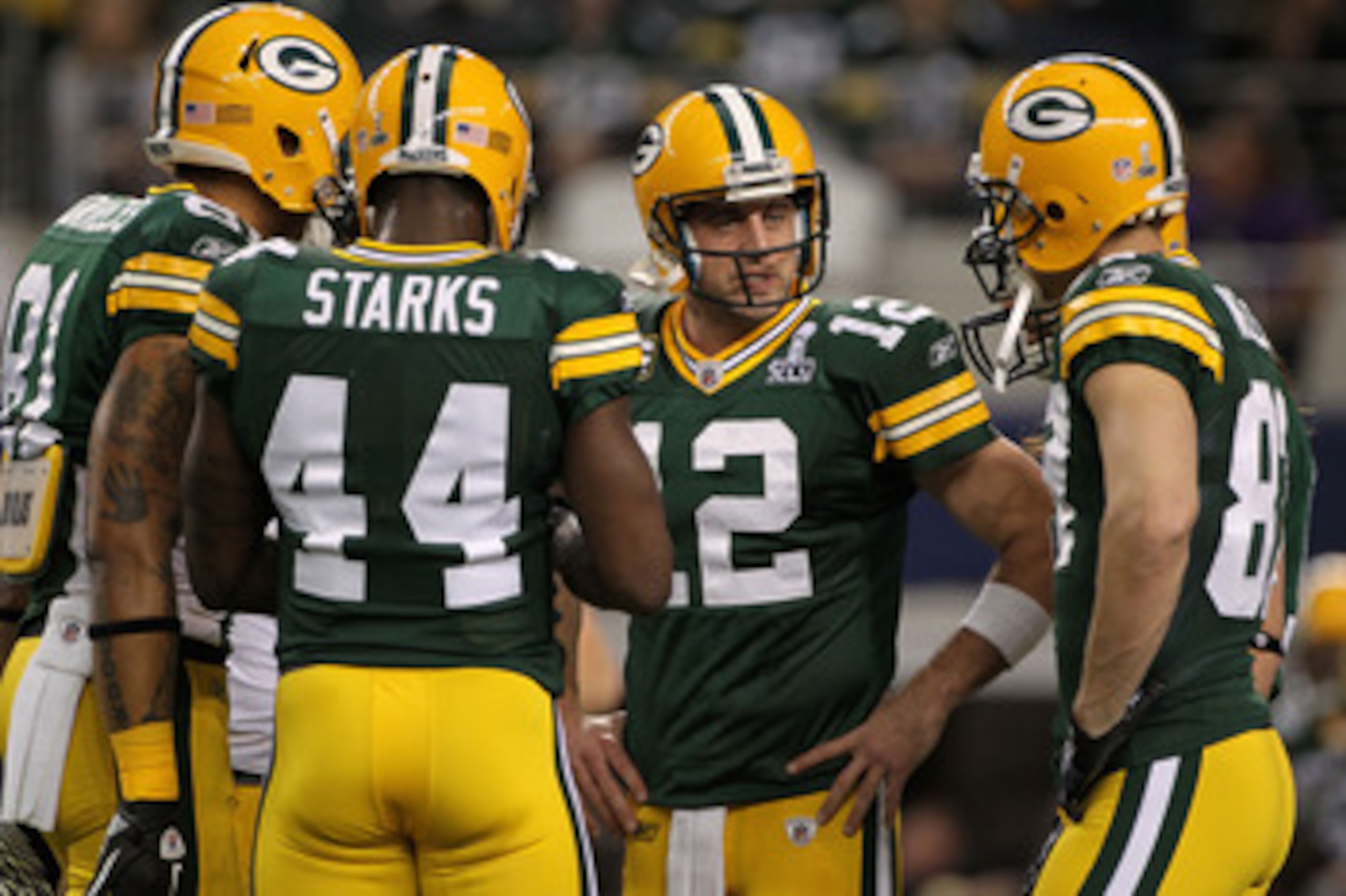 ARLINGTON, TX - FEBRUARY 06:  Aaron Rodgers #12 of the Green Bay Packers talks to teammates prior to their game against the Pittsburgh Steelers during Super Bowl XLV at Cowboys Stadium on February 6, 2011 in Arlington, Texas.  (Photo by Doug Pensinger/Get