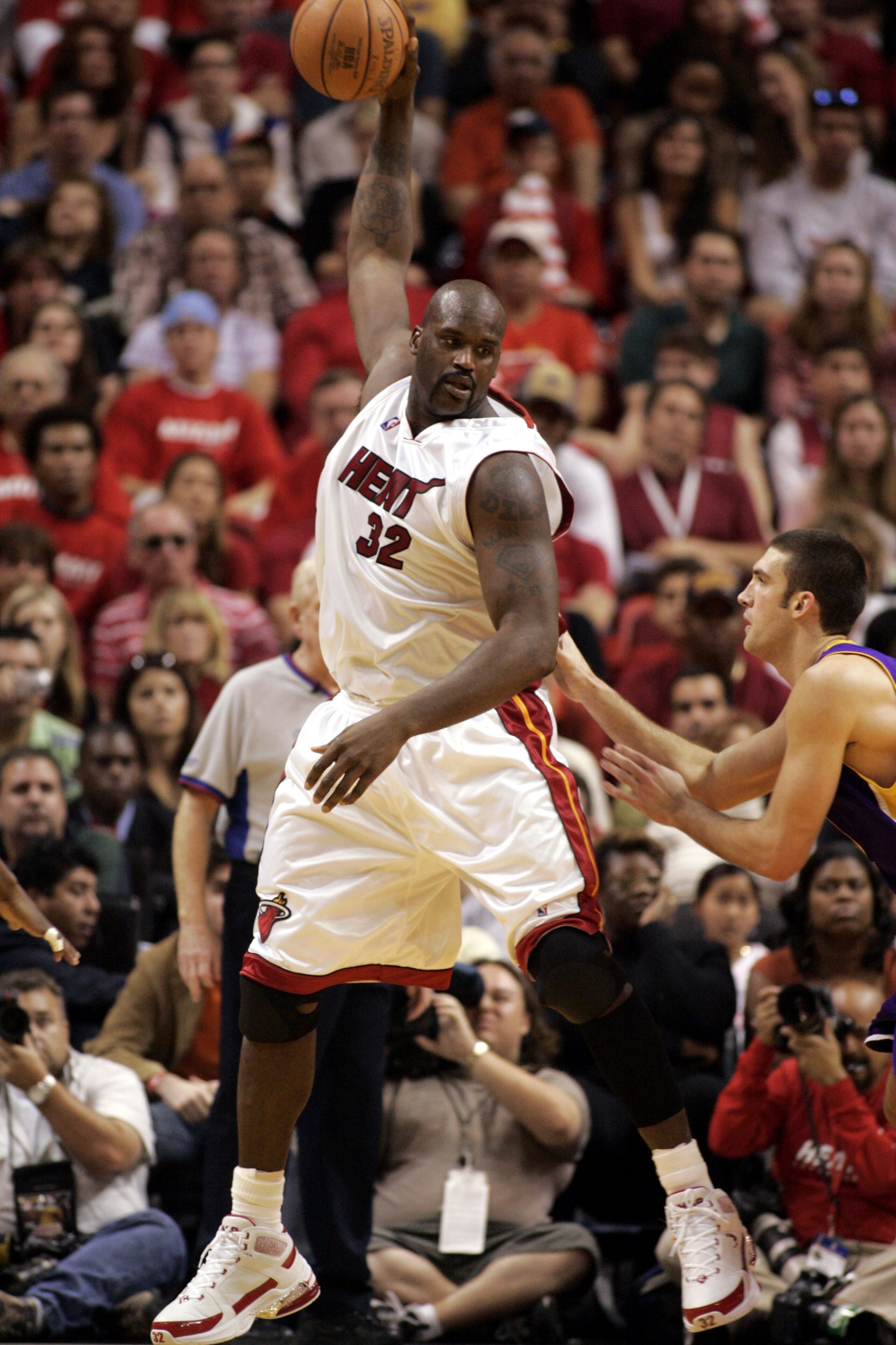 MIAMI - DECEMBER 25: Center Shaquille O'Neal #32 of the Miami Heat tangles with center Chris Mihm #31 of the Los Angeles Lakers on December 25, 2005 at the American Airlines Arena in Miami, Florida. The Heat defeated the Lakers 97-92.  NOTE TO USER: User