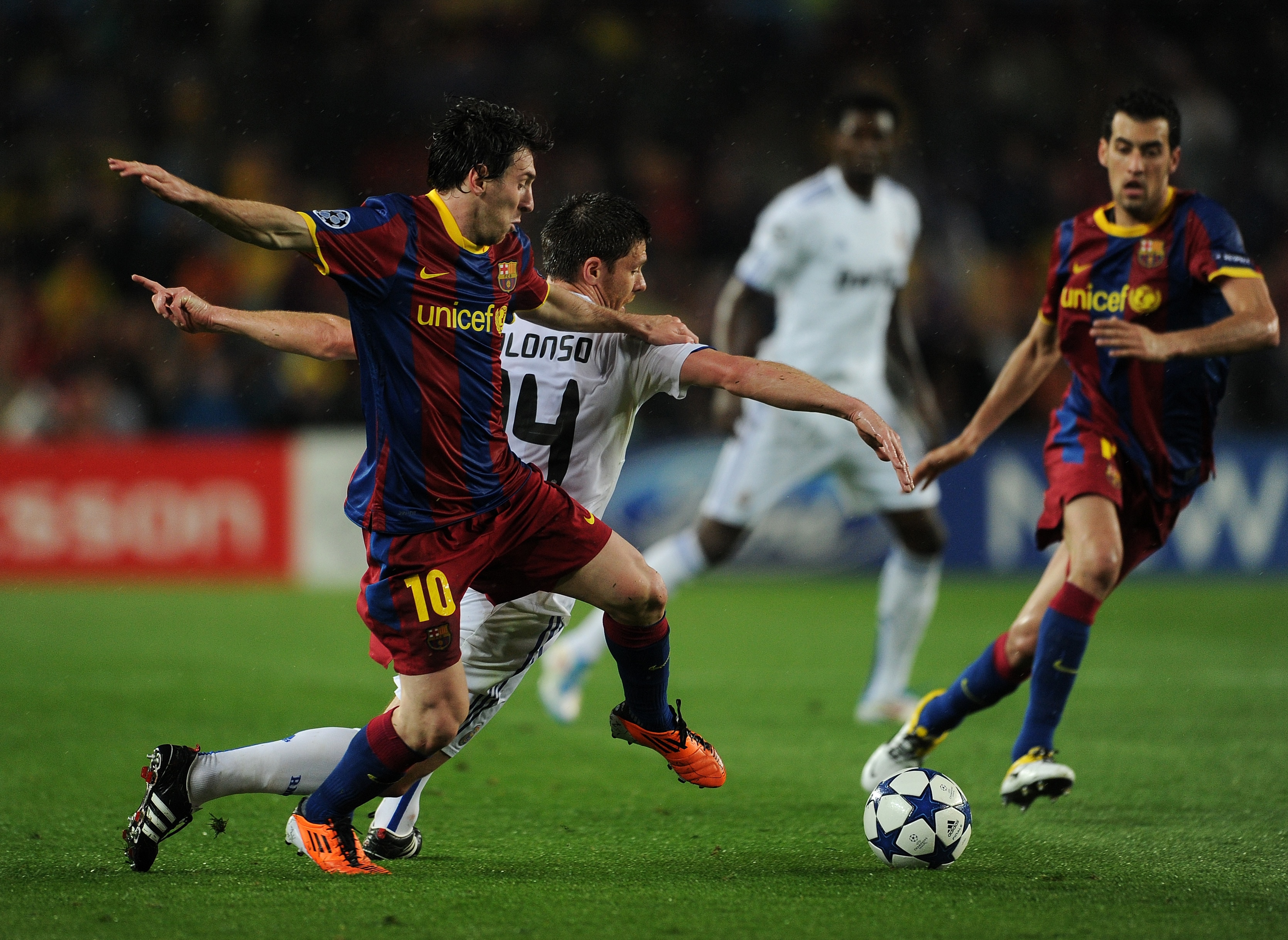 BARCELONA, SPAIN - MAY 03:  Lionel Messi (L) of Barcelona duels for the ball with Xabi Alonso of Real Madrid during the UEFA Champions League Semi Final second leg match between Barcelona and Real Madrid at the Camp Nou stadium on May 3, 2011 in Barcelona