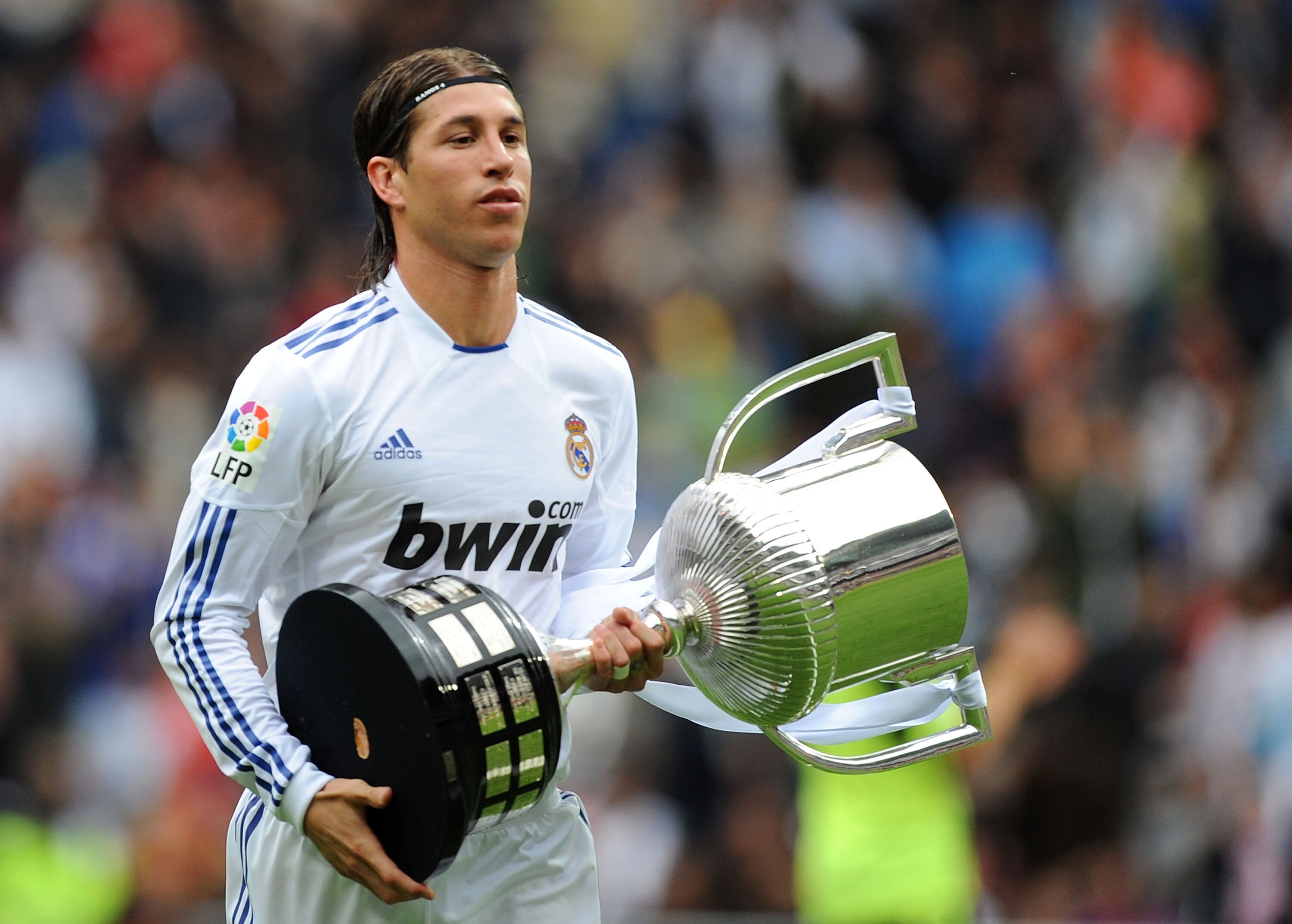 MADRID, SPAIN - APRIL 30: Sergio Ramos of Real Madrid walks away with the recently won Copa del Rey trophy before the La Liga match between Real Madrid and Real Zaragona at Estadio Santiago Bernabeu on April 30, 2011 in Madrid, Spain.  (Photo by Denis Doy