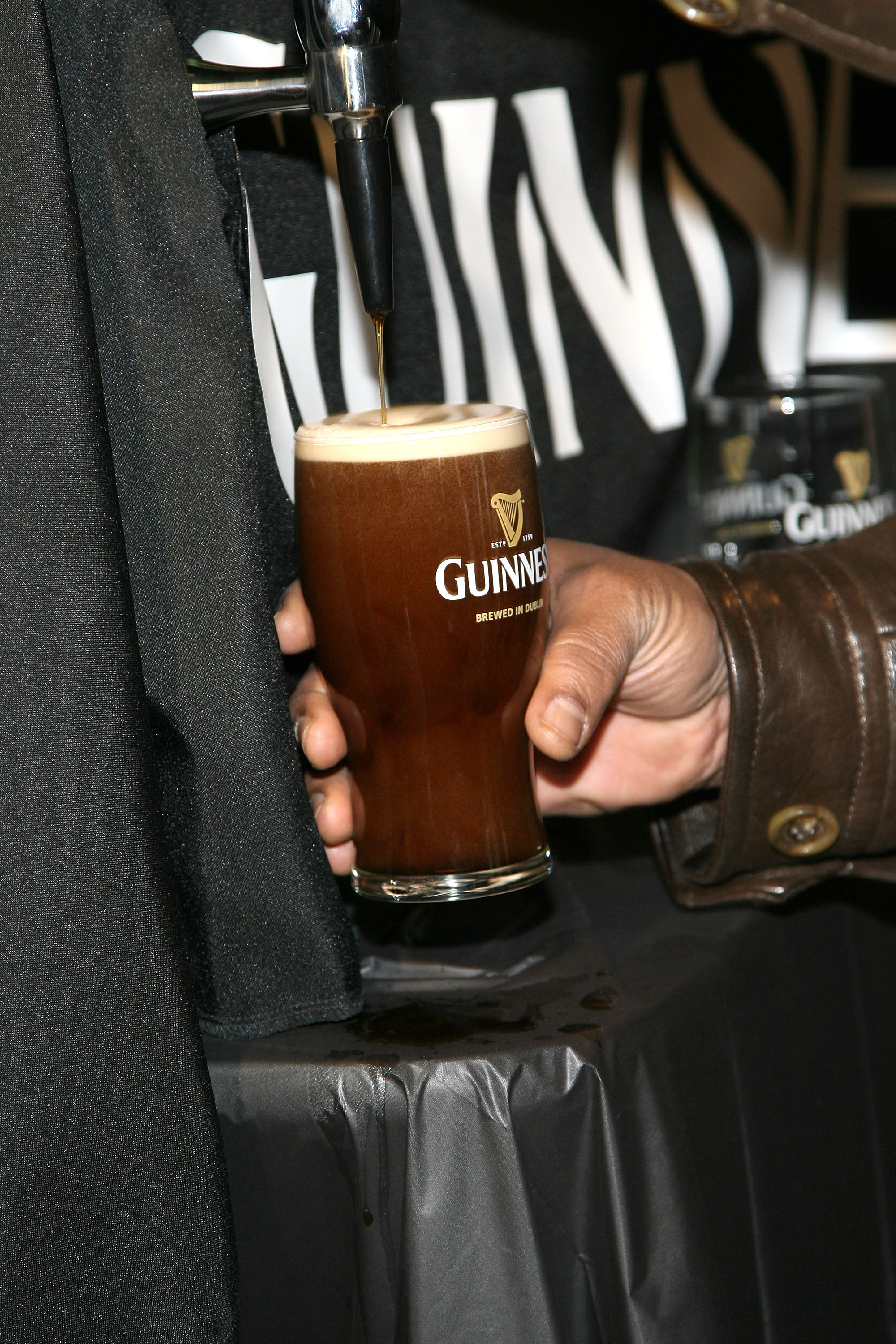ARLINGTON, TX - FEBRUARY 03:  Former NFL player Jerome Bettis competes in the Guinness Perfect Pint Pour-Off at Buffalo Wild Wings on February 3, 2011 in Arlington, Texas.  (Photo by Maury Phillips/Getty Images for Guinness)