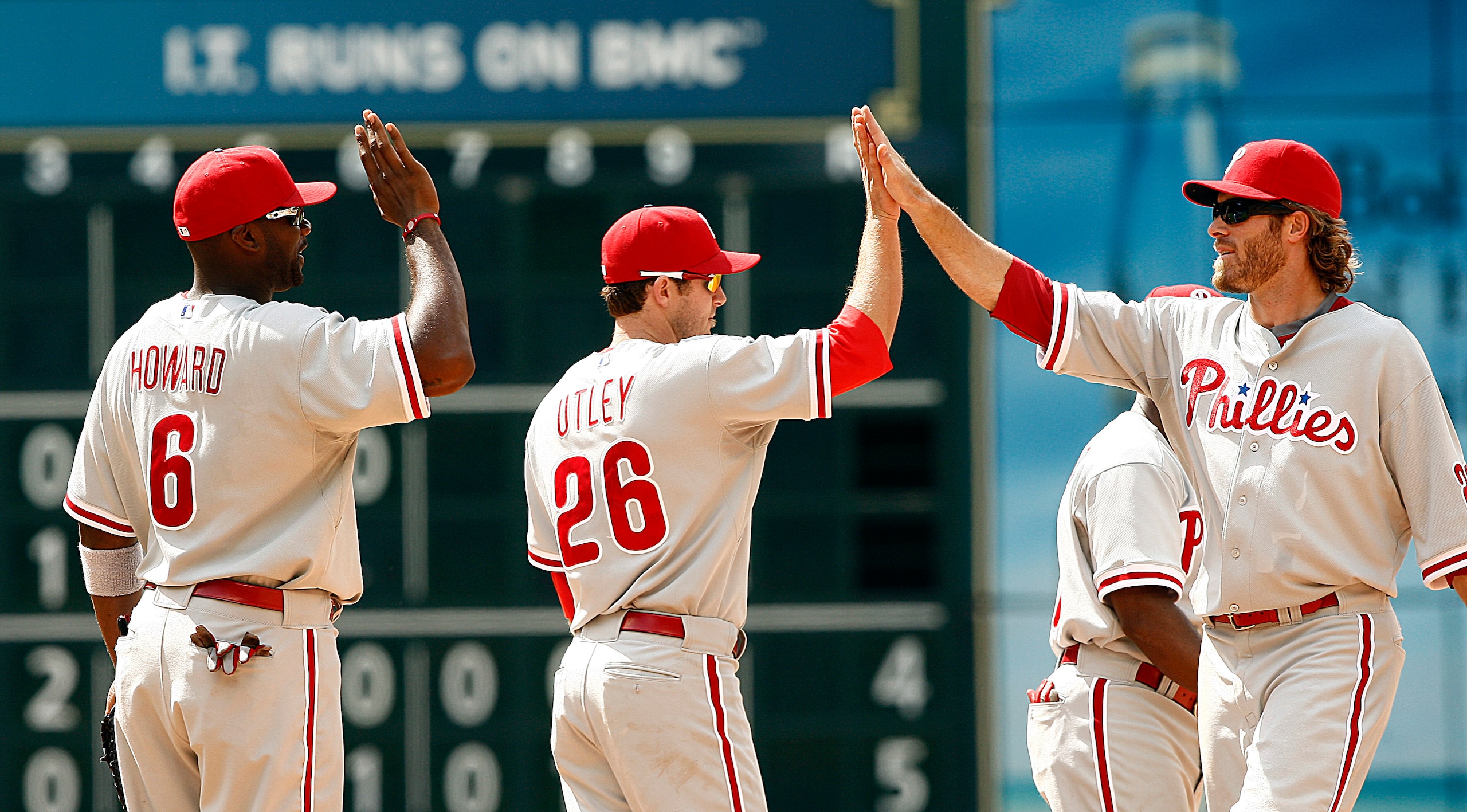 HOUSTON - APRIL 11:  Jayson Werth #28 of the Philadelphia Phillies (R) high fives Chase Utley #26 and Ryan Howard #6 after defeating the Houston Astros 2-1 at Minute Maid Park on April 11, 2010 in Houston, Texas.  (Photo by Bob Levey/Getty Images)