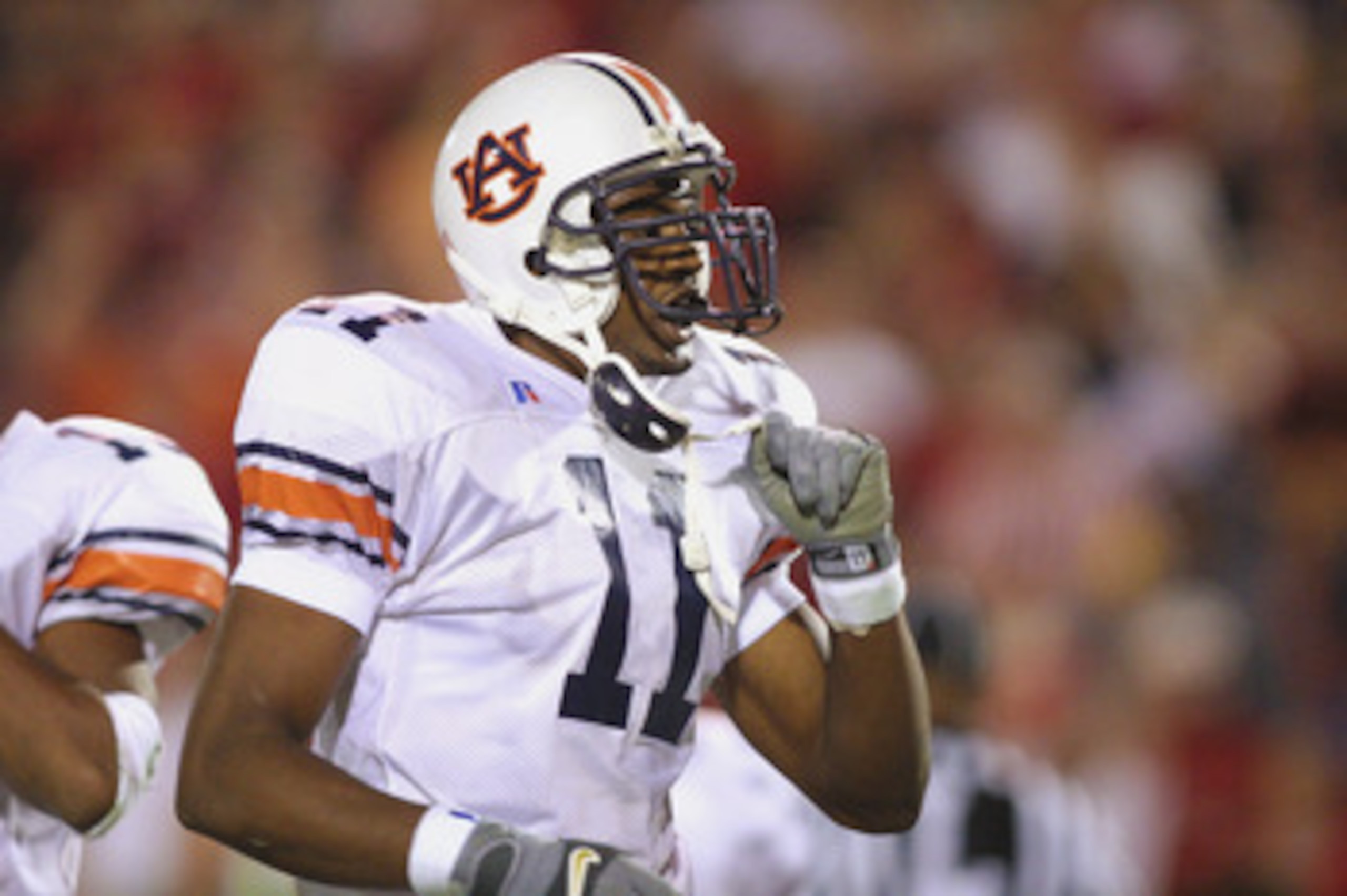 ATHENS, GA - NOVEMBER 10:  Linebacker Karlos Dansby #11 of the Auburn Tigers takes off his chin strap during the SEC football game against the Georgia Bulldogs on November 10, 2001 at Sanford Stadium in Athens, Georgia. Auburn won 24-17.  (Photo by Scott