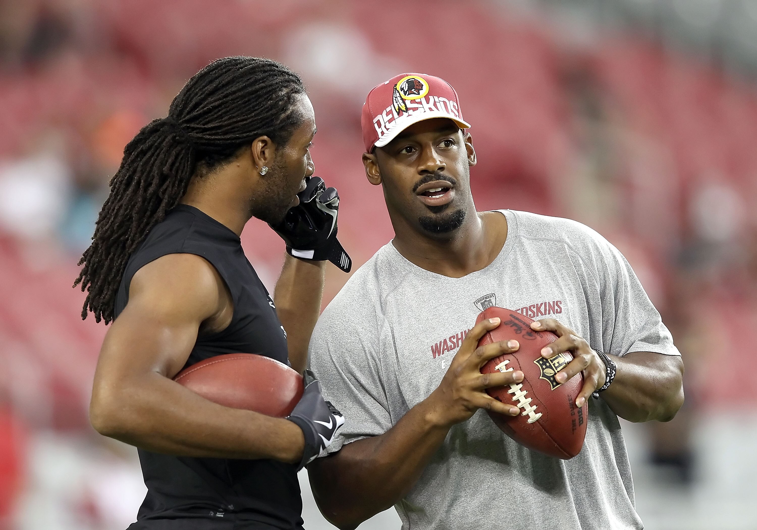 GLENDALE, AZ - SEPTEMBER 02:  Quarterback Donovan McNabb #5 of the Washington Redskins talks with Larry Fitzgerald #11 of the Arizona Cardinals before the preseason NFL game at the University of Phoenix Stadium on September 2, 2010 in Glendale, Arizona. T