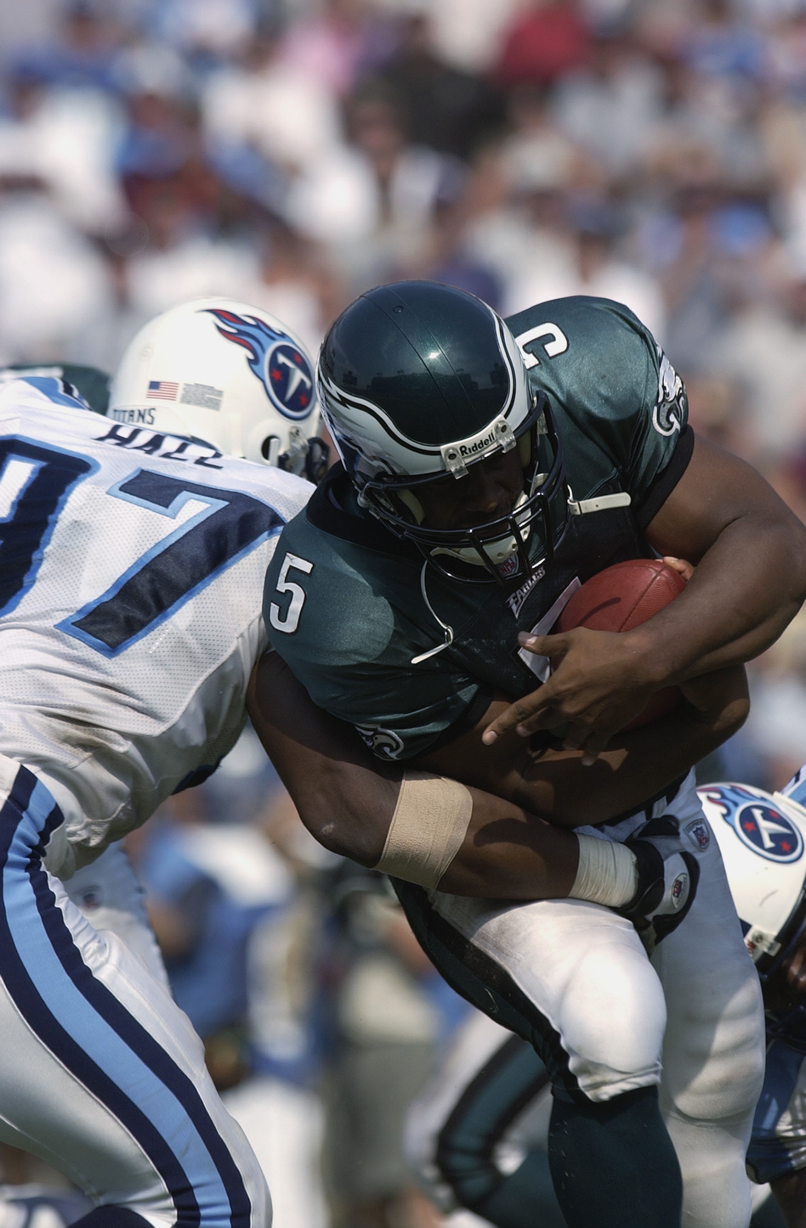 NASHVILLE, TN - SEPTEMBER 8:  Quarterback Donovan McNabb #5 of the Philadelphia Eagles runs past defensive end Carlos Hall #97 of the Tennessee Titans during the NFL game on September 8, 2002 at the Coliseum in Nashville, Tennessee. The Titans defeated th