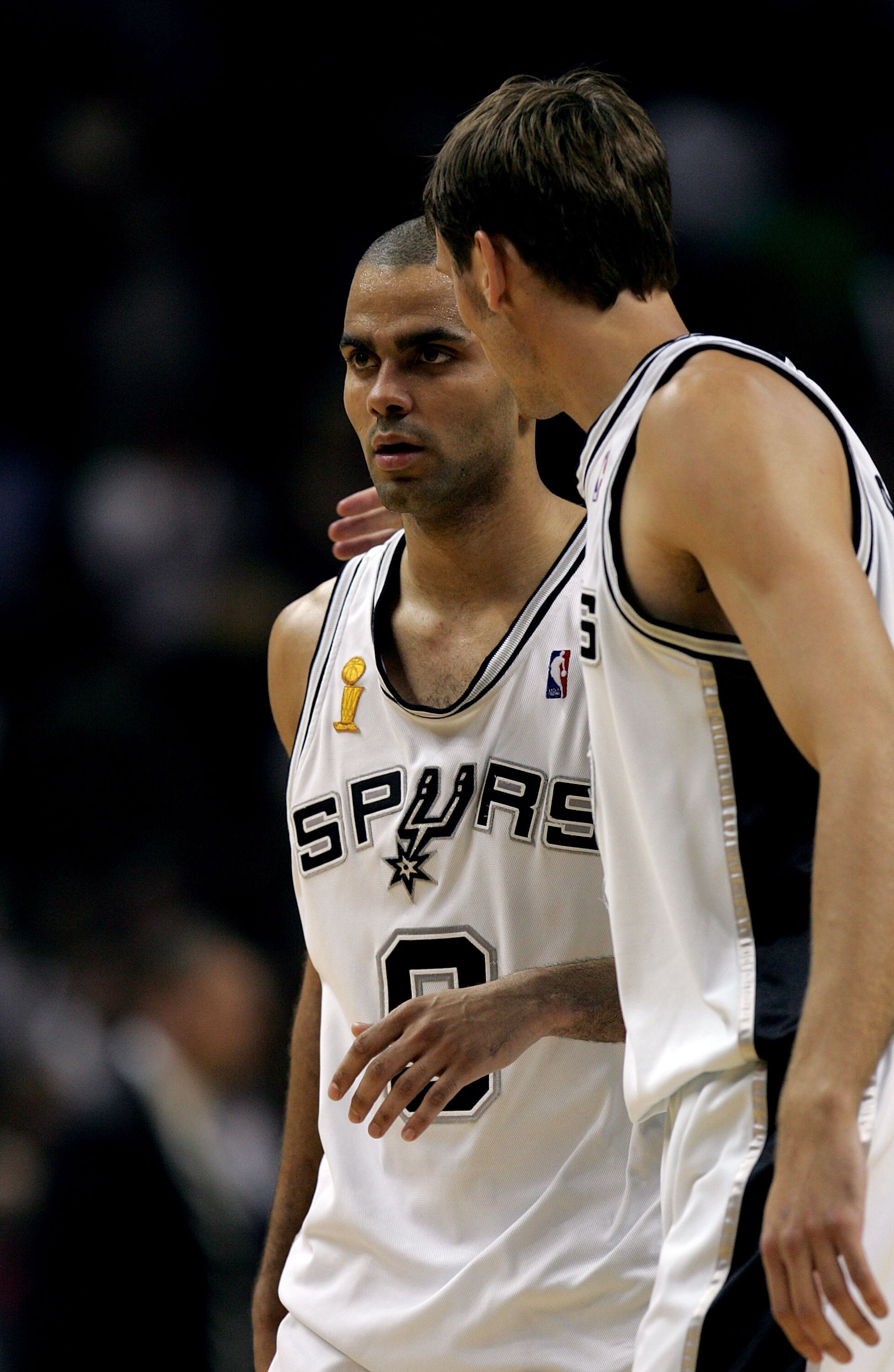 SAN ANTONIO - JUNE 9:  Tony Parker #9 walks off the court with teammate Brent Barry #17 of the San Antonio Spurs after defeating the Detroit Pistons in Game one of the 2005 NBA Finals at SBC Center on June 9, 2005 in San Antonio, Texas.  The Spurs defeate