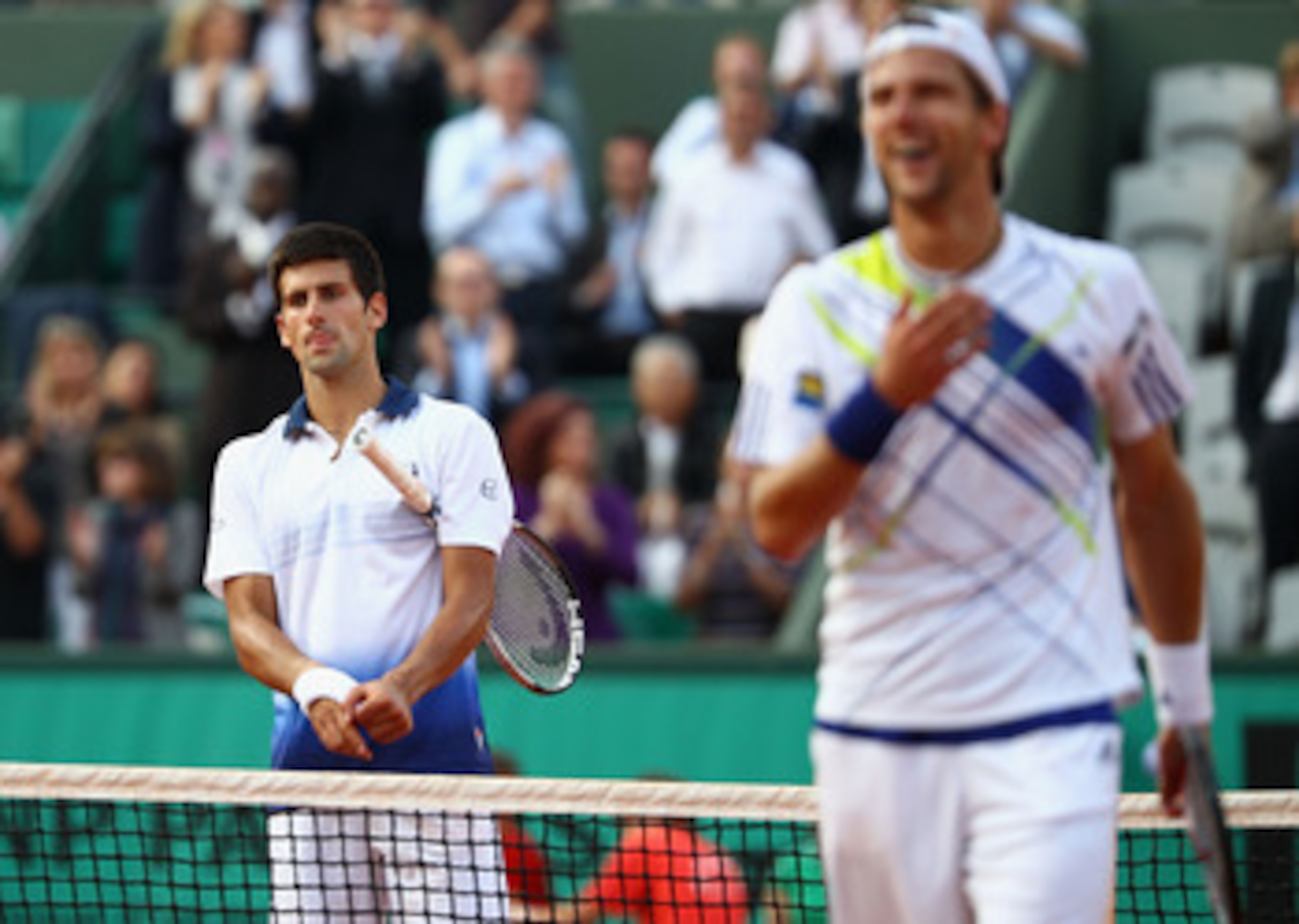 LONDON - JULY 06:  Novak Djokovic of Serbia loses his footing and his racquet during the Men's Singles quarter-final match against Marcos Baghdatis of Cyprus during day eleven of the Wimbledon Lawn Tennis Championships at the All England Lawn Tennis and C