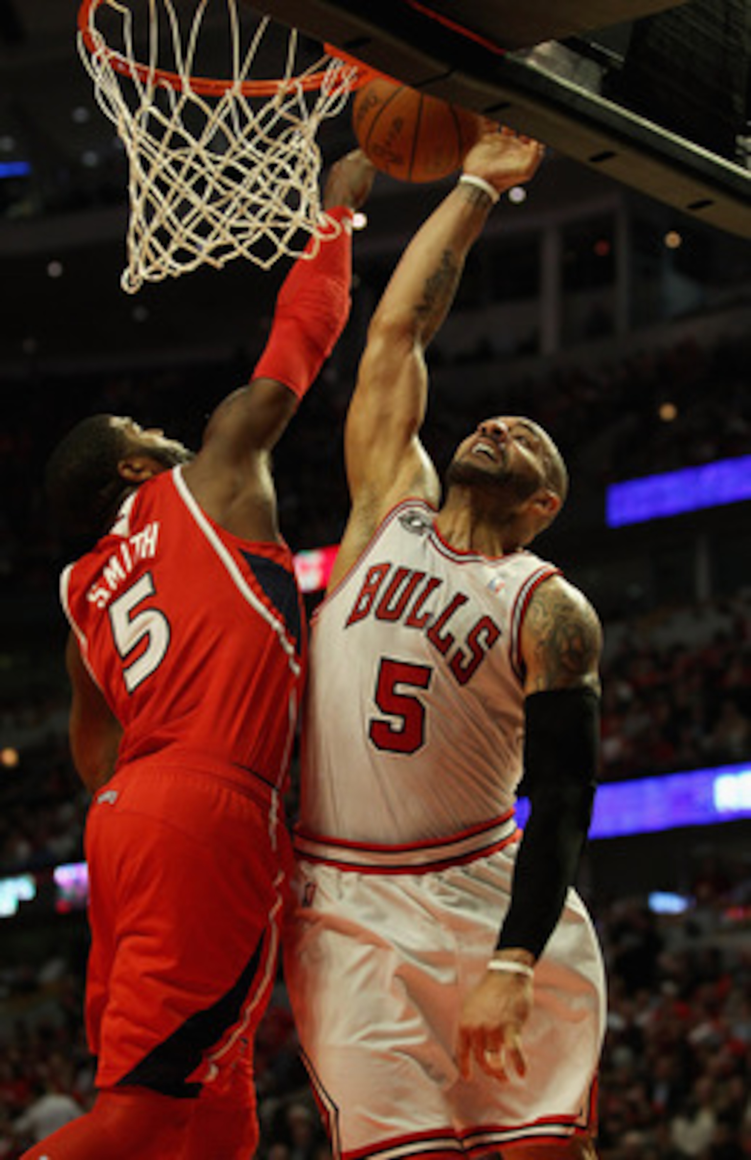 CHICAGO, IL - MAY 04: Josh Smith #5 of the Atlanta Hawks gets his hand on the ball as Carlos Boozer #5 of the Chicago Bulls attempts a dunk in Game Two of the Eastern Conference Semifinals in the 2011 NBA Playoffs at the United Center on May 4, 2011 in Ch