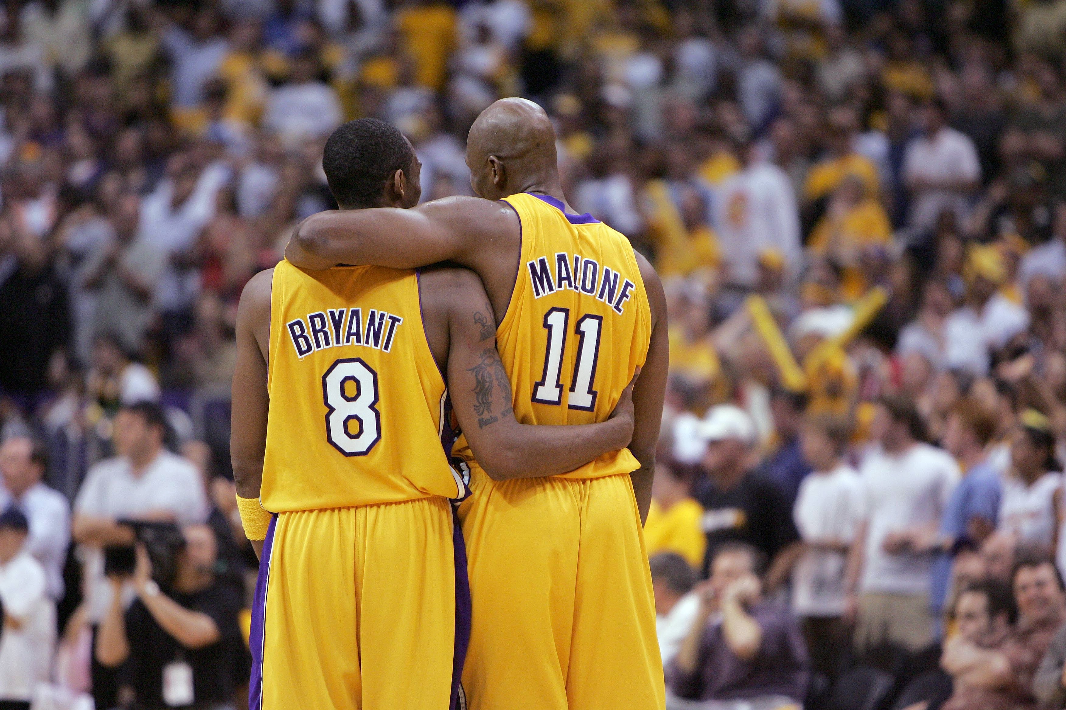 LOS ANGELES - MAY 31:  Kobe Bryant #8 and Karl Malone #11 of the Los Angeles Lakers walk downcourt in Game six of the Western Conference Finals against the Minnesota Timberwolves during the 2004 NBA Playoffs on May 31, 2004 at Staples Center in Los Angele