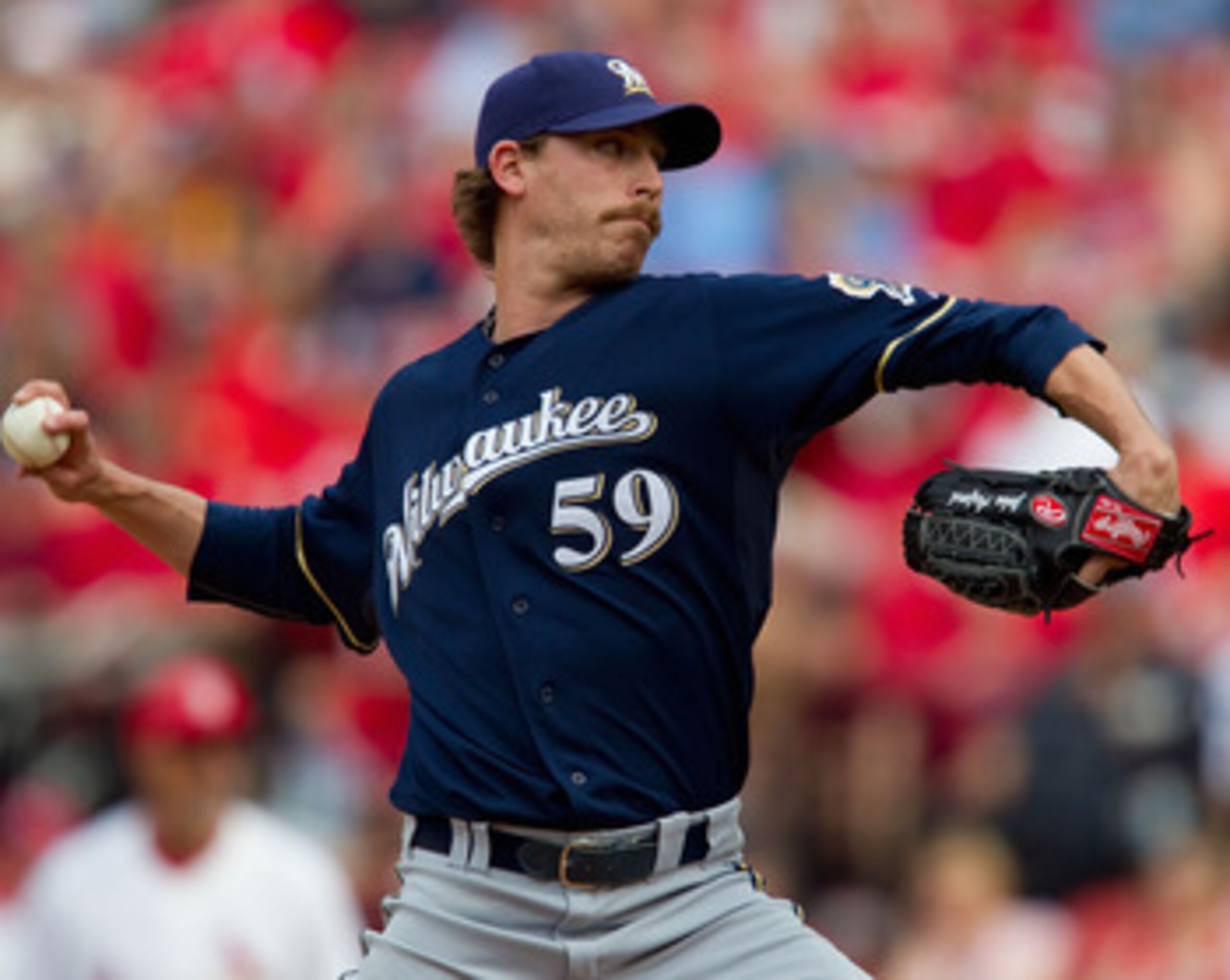 ST. LOUIS, MO - MAY 7:  Reliever John Axford #59 of the Milwaukee Brewers pitches against the St. Louis Cardinals at Busch Stadium on May 7, 2011 in St. Louis, Missouri.  (Photo by Dilip Vishwanat/Getty Images)