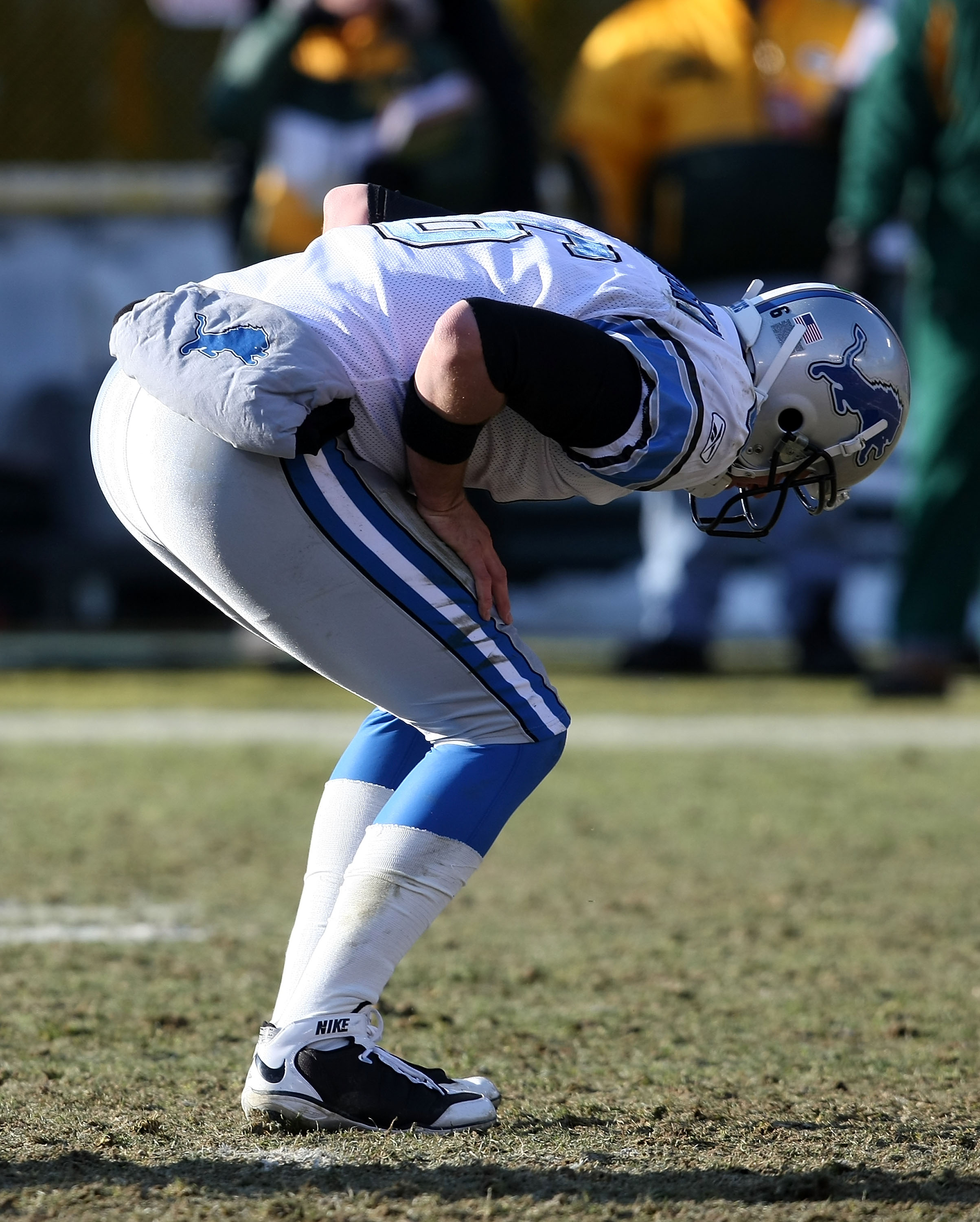 GREEN BAY, WI - DECEMBER 28: Dan Orlovsky #6 of the Detroit Lions bends over in pain after being hit throwing a pass against the Green Bay Packers on December 28, 2008 at Lambeau Field in Green Bay, Wisconsin. (Photo by Jonathan Daniel/Getty Images)