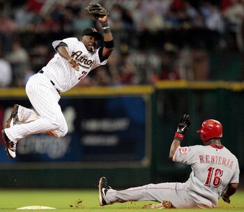 HOUSTON - MAY 09:  Second baseman Bill Hall #22 of the Houston Astros leaps to catch a throw from catcher J.R. Towles as Edgar Renteria #16 of the Cincinnati Reds slides in safely at Minute Maid Park on May 9, 2011 in Houston, Texas.  (Photo by Bob Levey/
