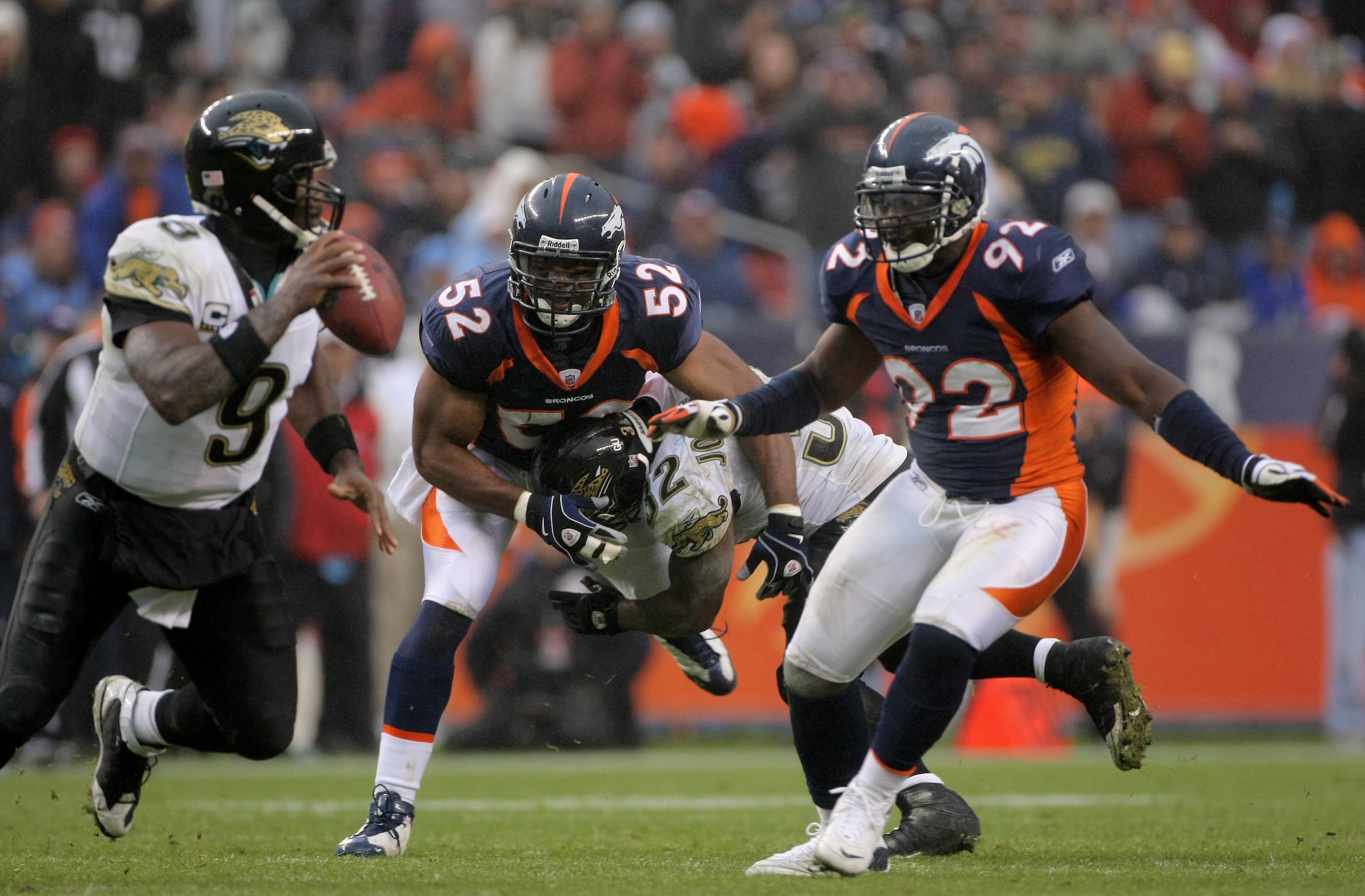 DENVER - OCTOBER 12: Linebacker Louis Green #52 of the Denver Broncos is blocked by Maurice Jones-Drew #32 of the Jacksonville Jaguars as Elvis Dumervil #92 of the Broncos pressures quarterback David Garrard #9 of the Jaguars during NFL action at Invesco DENVER - OCTOBER 12: Linebacker Louis Green #52 of the Denver Broncos is blocked by Maurice Jones-Drew #32 of the Jacksonville Jaguars as Elvis Dumervil #92 of the Broncos pressures quarterback David Garrard #9 of the Jaguars during NFL action at Invesco