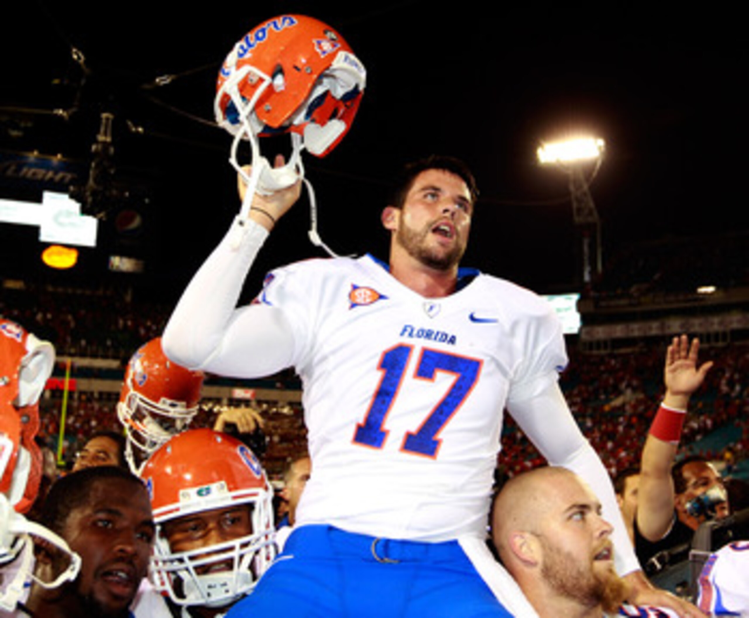 JACKSONVILLE, FL - OCTOBER 30:  Chas Henry #17 of the Florida Gators raises his helmet in vicrtory following the game against the Georgia Bulldogs at EverBank Field on October 30, 2010 in Jacksonville, Florida.  (Photo by Sam Greenwood/Getty Images)