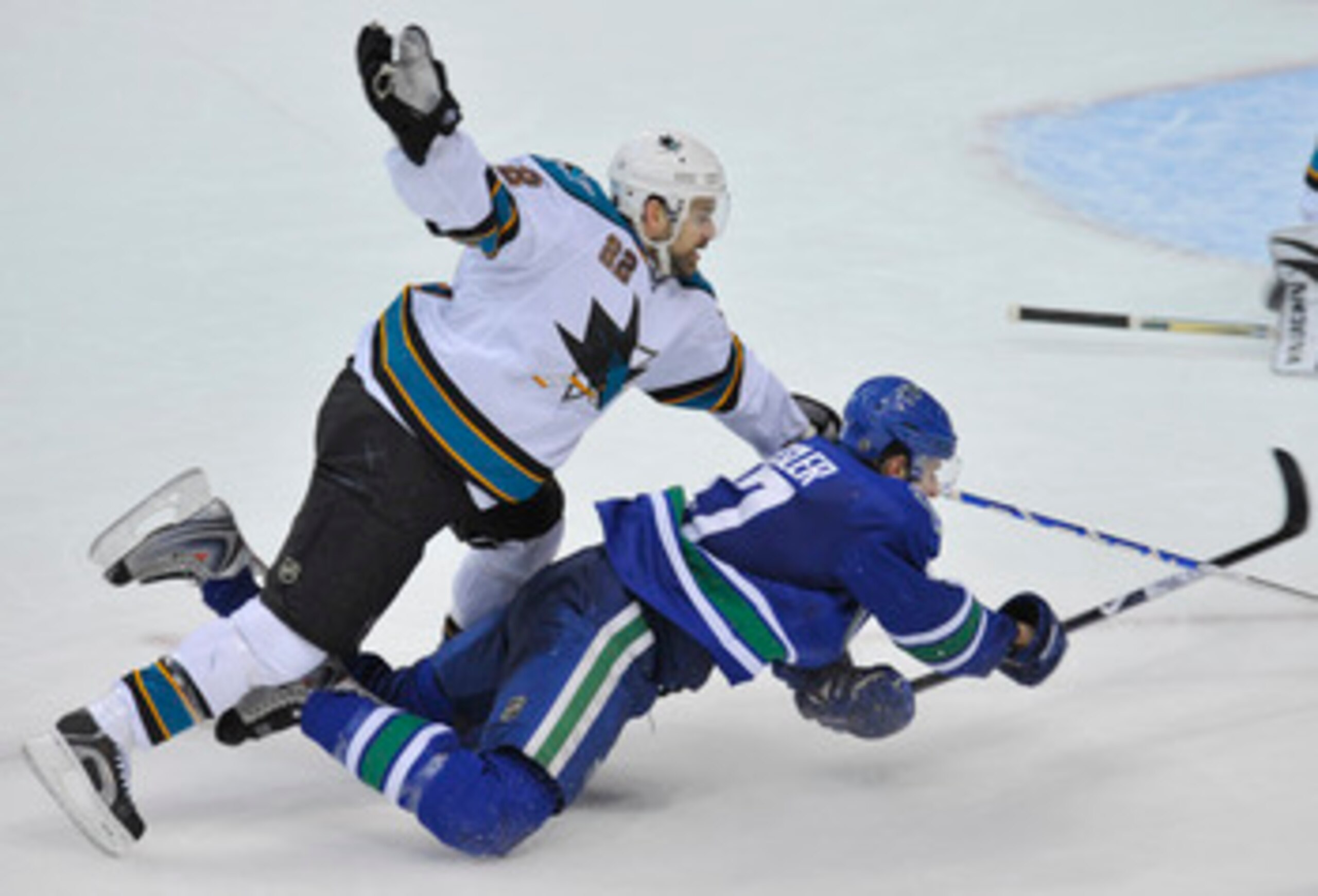 VANCOUVER, CANADA - MARCH 7: Dan Boyle #22 of the San Jose Sharks falls to the ice on top of Ryan Kesler #17 of the Vancouver Canucks during their game at General Motors Place March 7, 2009 in Vancouver, Canada.   (Photo by Nick Didlick/Getty Images)