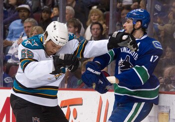 VANCOUVER, CANADA - JANUARY 20: Ryan Kesler #17 of the Vancouver Canucks and Derek Joslin #65 of the San Jose Sharks push and shove behind the play during the second period in NHL action on January 20, 2011 at Rogers Arena in Vancouver, BC, Canada.  (Phot