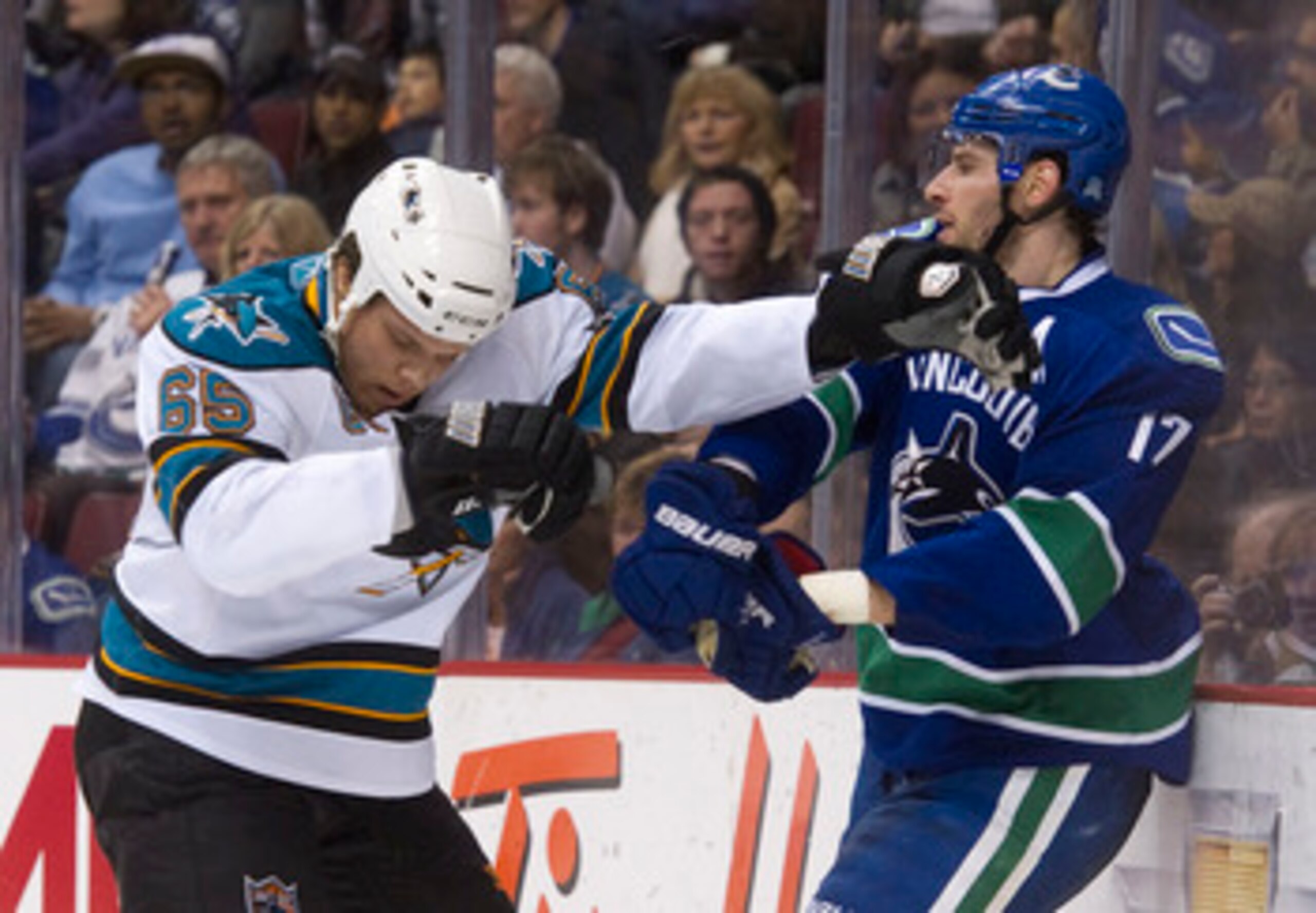 VANCOUVER, CANADA - JANUARY 20: Ryan Kesler #17 of the Vancouver Canucks and Derek Joslin #65 of the San Jose Sharks push and shove behind the play during the second period in NHL action on January 20, 2011 at Rogers Arena in Vancouver, BC, Canada.  (Phot