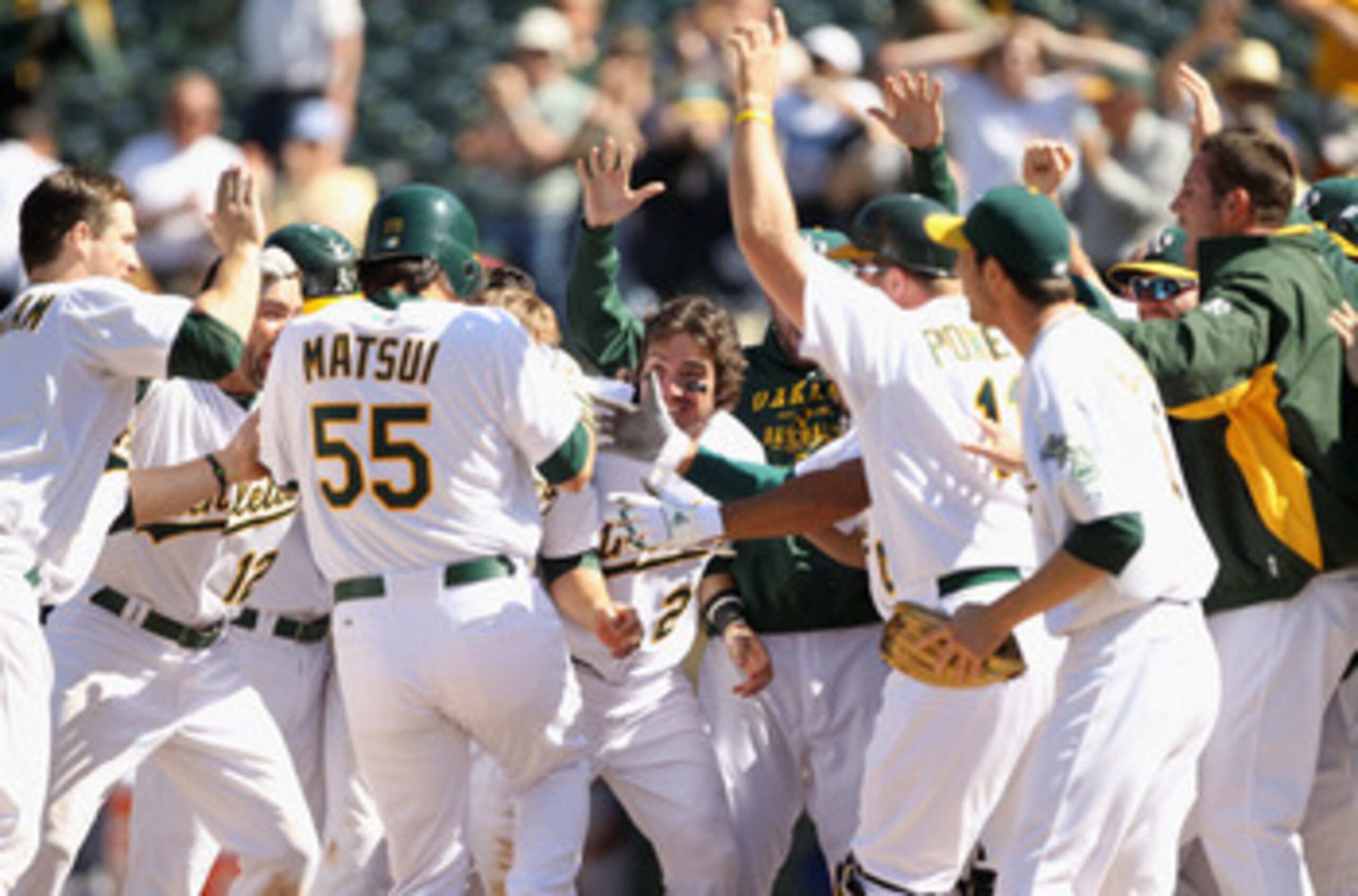 OAKLAND, CA - MAY 02:  Hideki Matsui #55 of the Oakland Athletics is congratulated by teammates after he hit a walk off home run to win the game in the tenth inning against the Texas Rangers at Oakland-Alameda County Coliseum on May 2, 2011 in Oakland, Ca