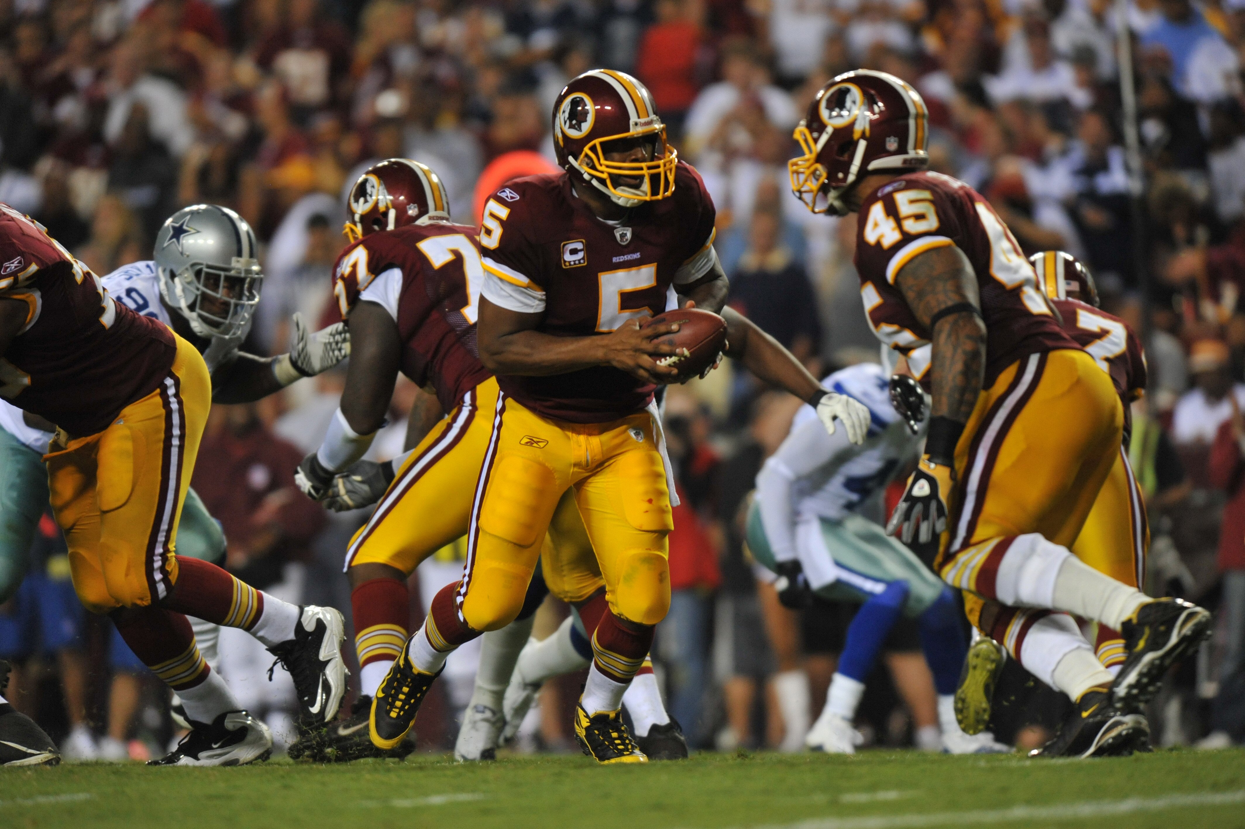 LANDOVER - SEPTEMBER 12:  Donovan McNabb #5 of the Washington Redskins hands off during the NFL season opener against the Dallas Cowboys at FedExField on September 12, 2010 in Landover, Maryland. The Redskins defeated the Cowboys 13-7. (Photo by Larry Fre