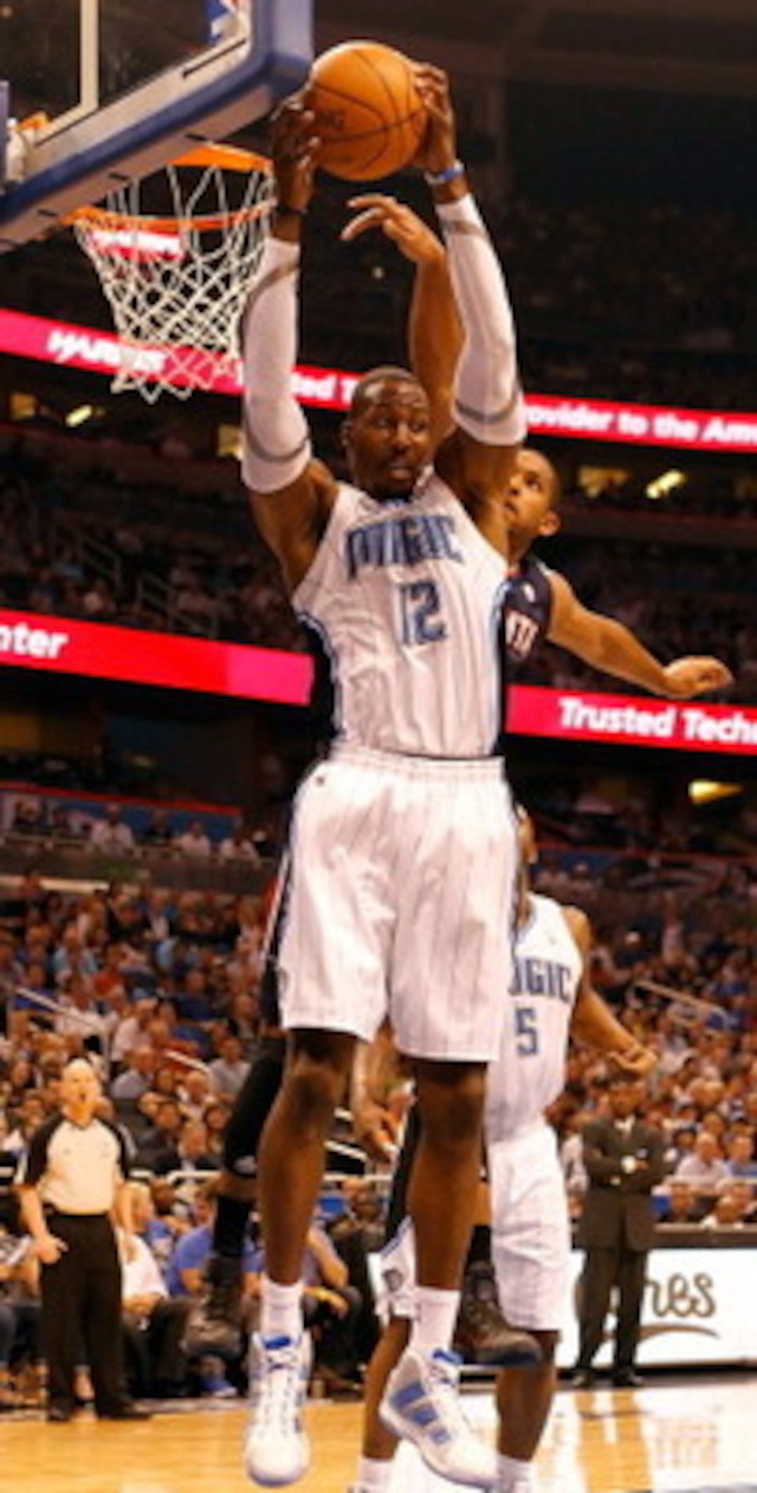 ORLANDO, FL - APRIL 26:  Dwight Howard #12 of the Orlando Magic rebounds against the Atlanta Hawks during Game Five of the Eastern Conference Quarterfinals of the 2011 NBA Playoffs on April 26, 2011 at the Amway Arena in Orlando, Florida.  NOTE TO USER: U