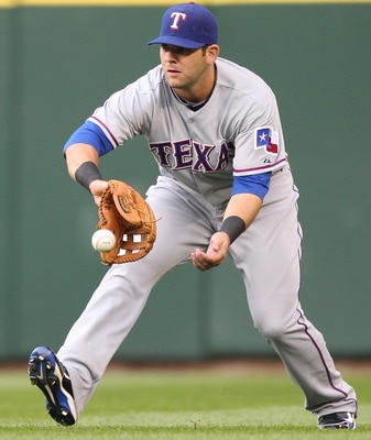 SEATTLE - MAY 04:  Mitch Moreland #18 of the Texas Rangers fields a base hit against the Seattle Mariners at Safeco Field on May 4, 2011 in Seattle, Washington. (Photo by Otto Greule Jr/Getty Images)