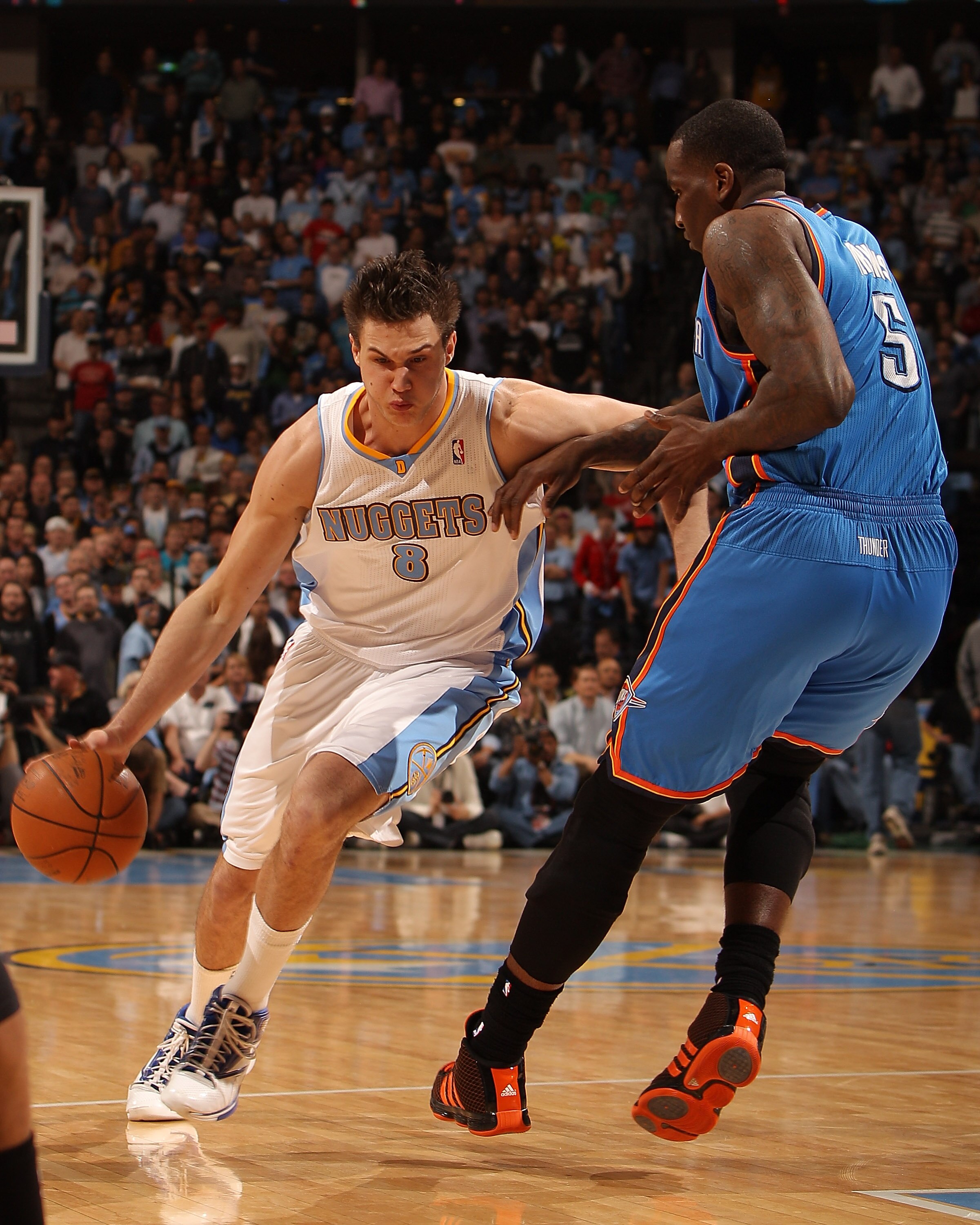 DENVER, CO - APRIL 25:  Danilo Gallinari #8 of the Denver Nuggets drives to the basket on Kendrick Perkins #5 of the Oklahoma City Thunder in Game Four of the Western Conference Quarterfinals in the 2011 NBA Playoffs at Pepsi Center on April 25, 2011 in D