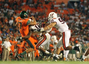 MIAMI - NOVEMBER 20:  Stephen Morris #17 of the Miami Hurricanes is sacked by Eddie Whitley #15 of the Virginia Tech Hokies at Sun Life Stadium on November 20, 2010 in Miami, Florida.  (Photo by Mike Ehrmann/Getty Images)