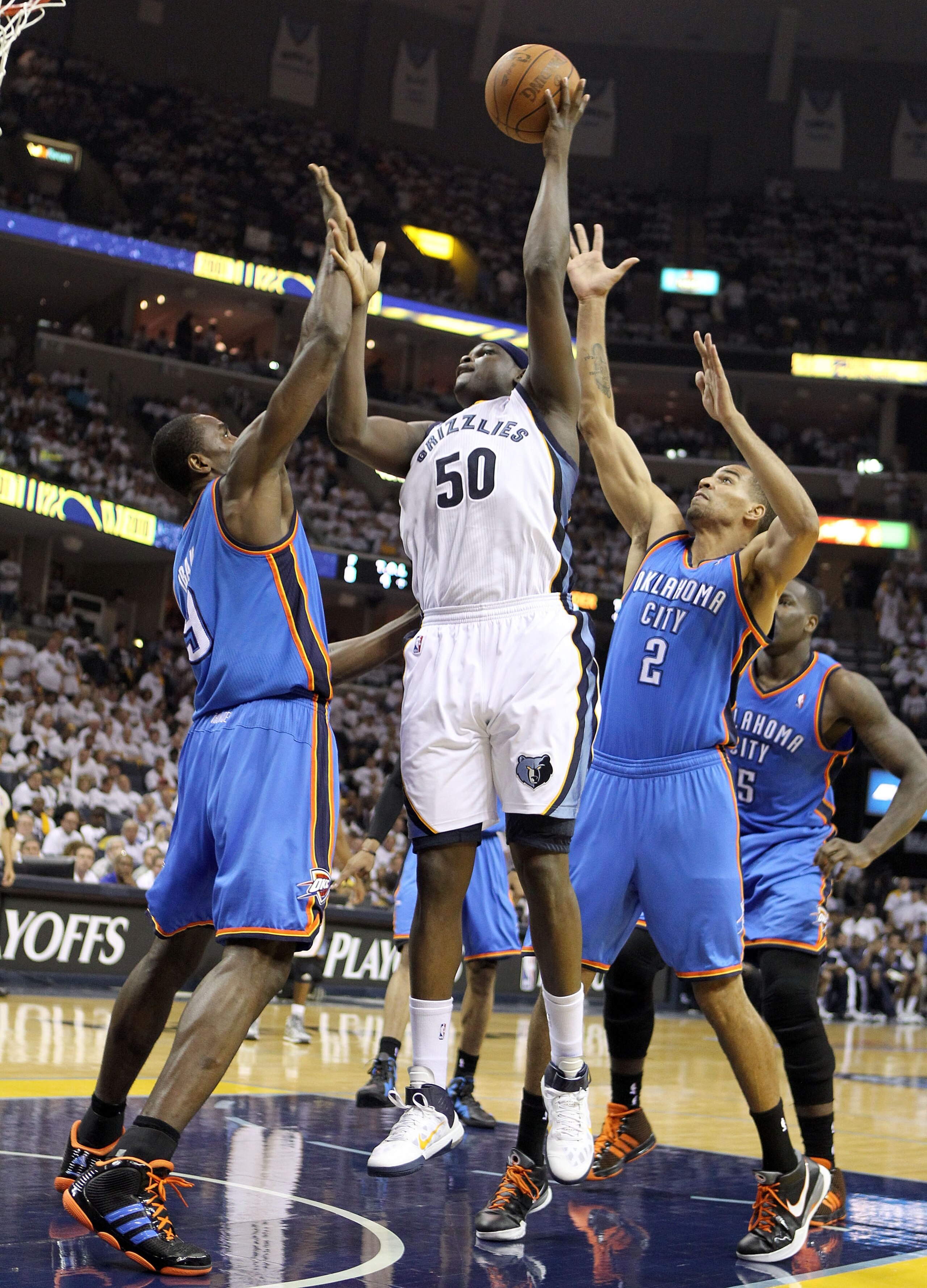 MEMPHIS, TN - MAY 09:  Zach Randolph #50 of the Memphis Grizzlies shoots the ball while defended by Serge Ibaka #9 and Thabo Sefolosha #2 of the Oklahoma City Thunder in Game Four of the Western Conference Semifinals in the 2011 NBA Playoffs at FedExForum