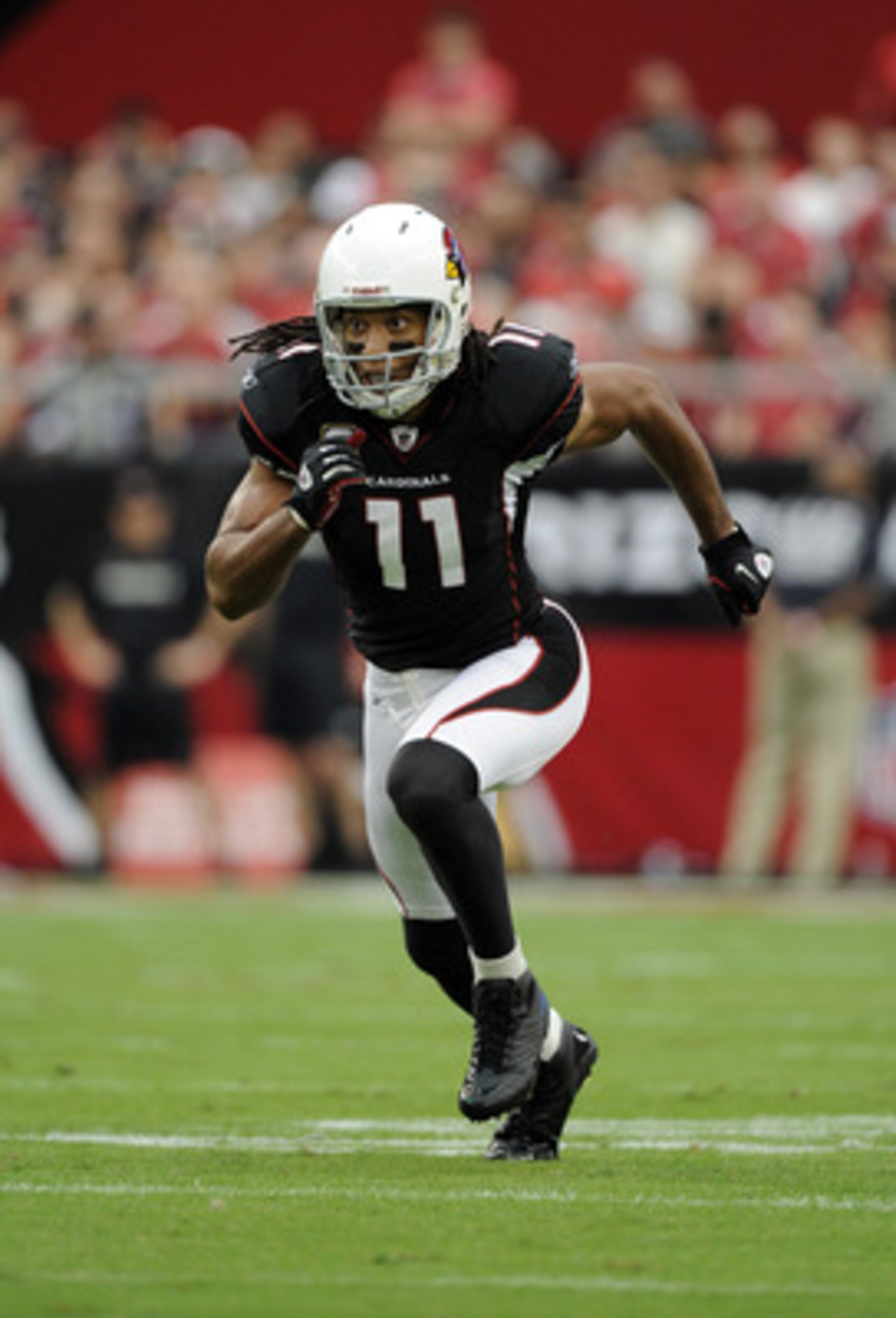 GLENDALE, AZ - OCTOBER 31:  Larry Fitzgerald #11 of the Arizona Cardinals comes off the line of scrimmage against the Tampa Bay Buccaneers at University of Phoenix Stadium on October 31, 2010 in Glendale, Arizona.  (Photo by Harry How/Getty Images)