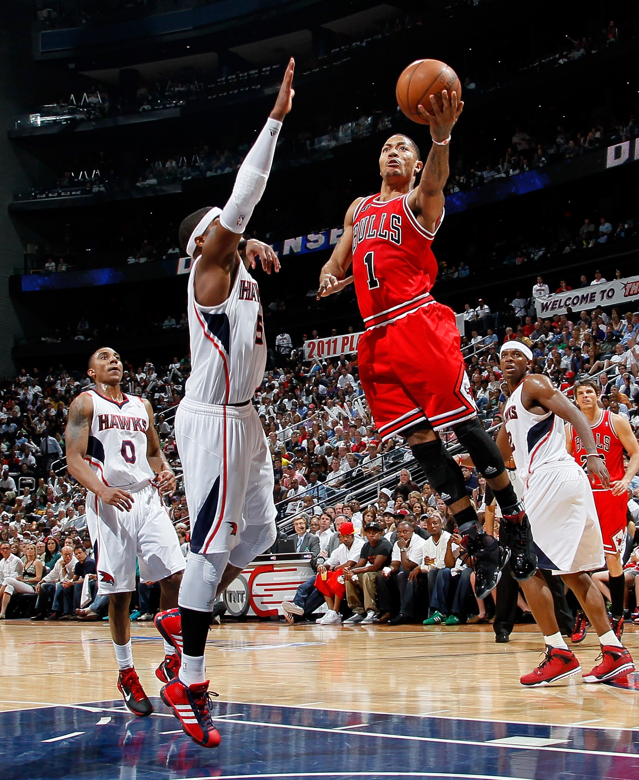 ATLANTA, GA - MAY 08:  Derrick Rose #1 of the Chicago Bulls drives against Josh Smith #5 of the Atlanta Hawks in Game Four of the Eastern Conference Semifinals in the 2011 NBA Playoffs at Phillips Arena on May 8, 2011 in Atlanta, Georgia.  NOTE TO USER: U
