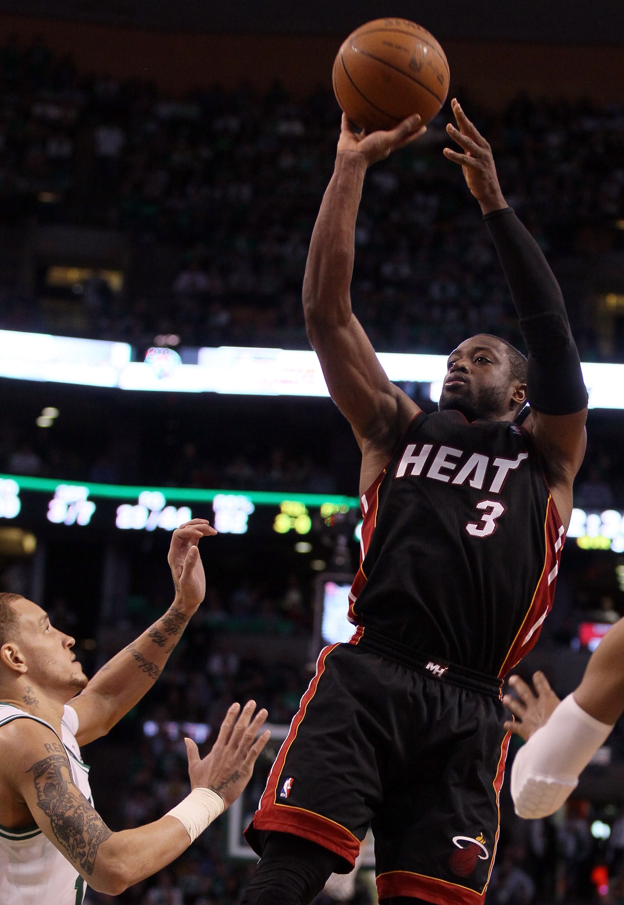 BOSTON, MA - MAY 09:  Dwyane Wade #3 of the Miami Heat takes a shot over Delonte West #13 of the Boston Celtics in Game Four of the Eastern Conference Semifinals in the 2011 NBA Playoffs on May 9, 2011 at the TD Garden in Boston, Massachusetts.  The Miami