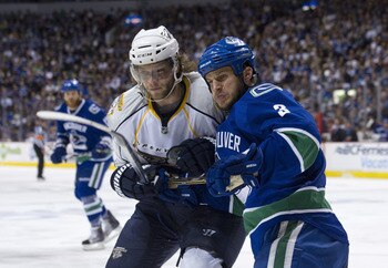 VANCOUVER, CANADA - MAY 7: Jonathon Blum #7 of the Nashville Predators holds Kevin Bieksa #3 of the Vancouver Canucks infront of the Vancouver goal during the first period in Game Five of the Western Conference Semifinals during the 2011 NHL Stanley Cup P